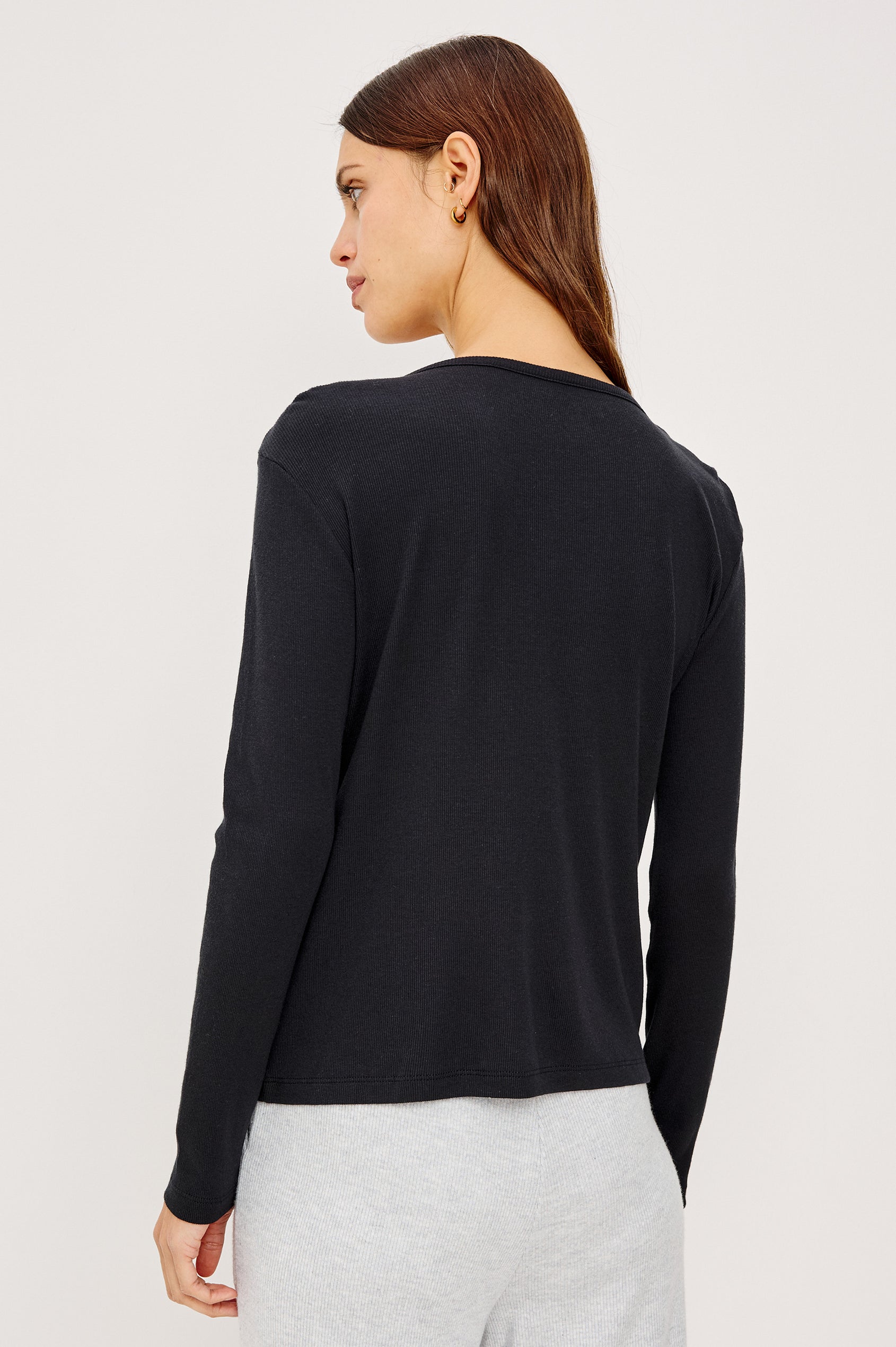 Essential Ribbed Henley With Front Placket and Long Sleeves in Black Colorway - Upper Body Back View Featured on Model