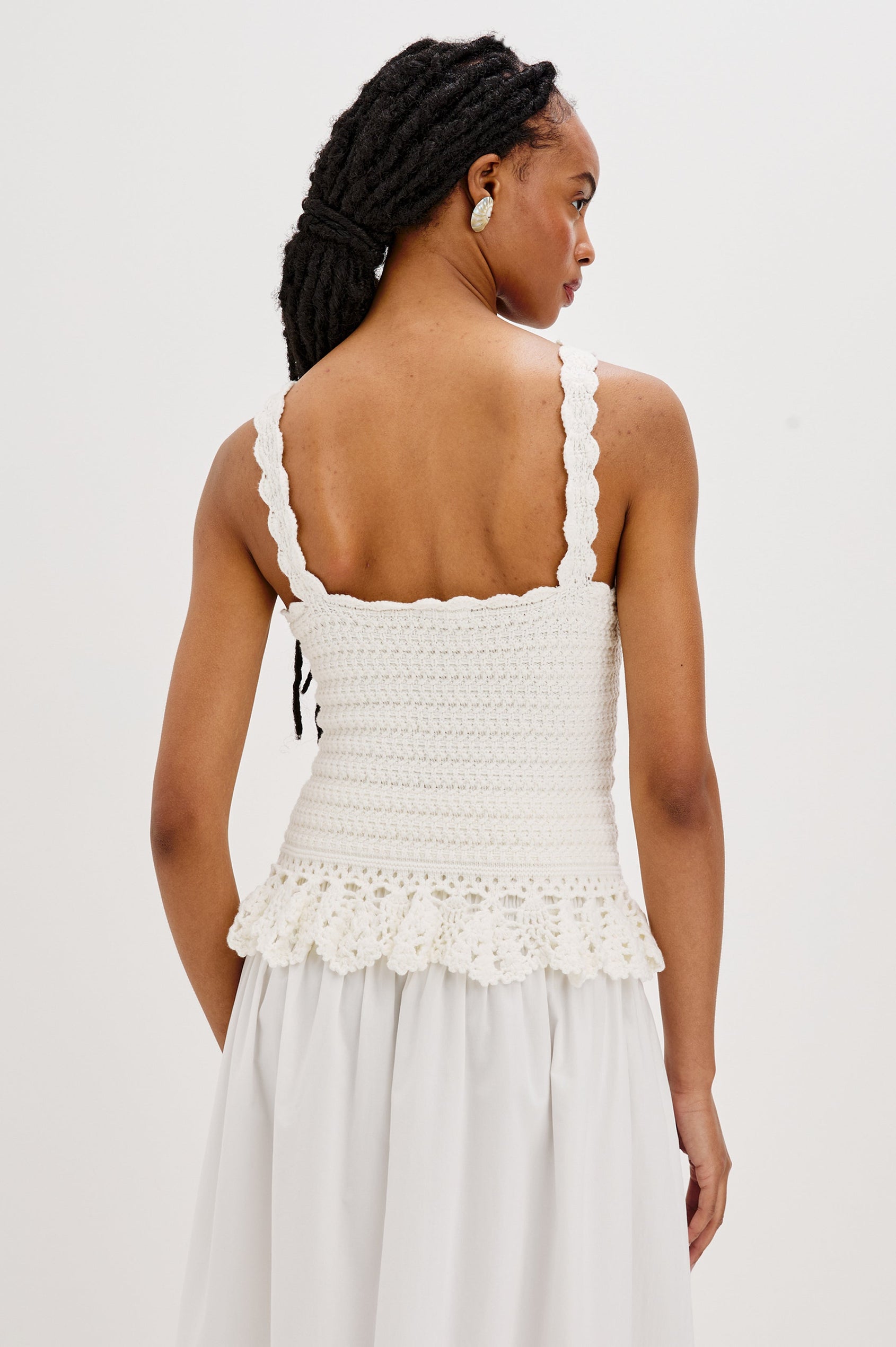 Estefania Tank Top with Scalloped Straps and a Small Peplum Embroidered Ruffle Hem in White Colorway. Back View Shown on Model.