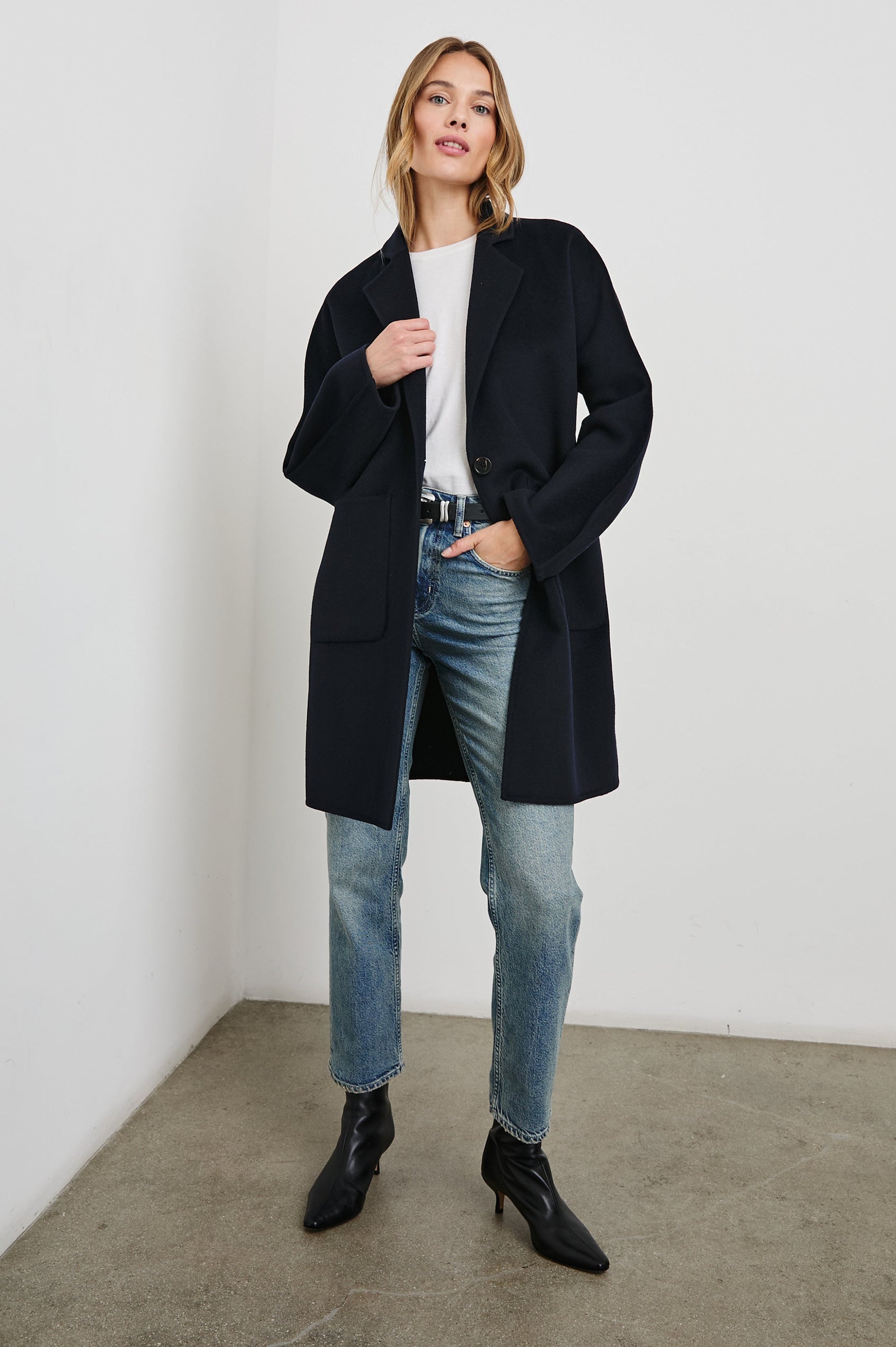 Everest Mid-Thigh Length Coat with Single Button Closure, Notched Lapels and Front Patch Pockets in Navy Colorway - Front Full Body View Featured on Model