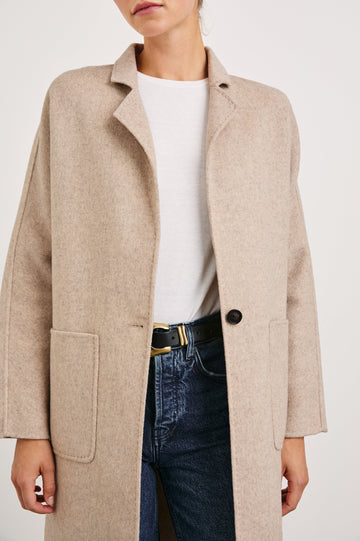 Everest Mid-Thigh Length Coat with Single Button Closure, Notched Lapels and Front Patch Pockets in Oatmeal Colorway - Front View Featured on Model