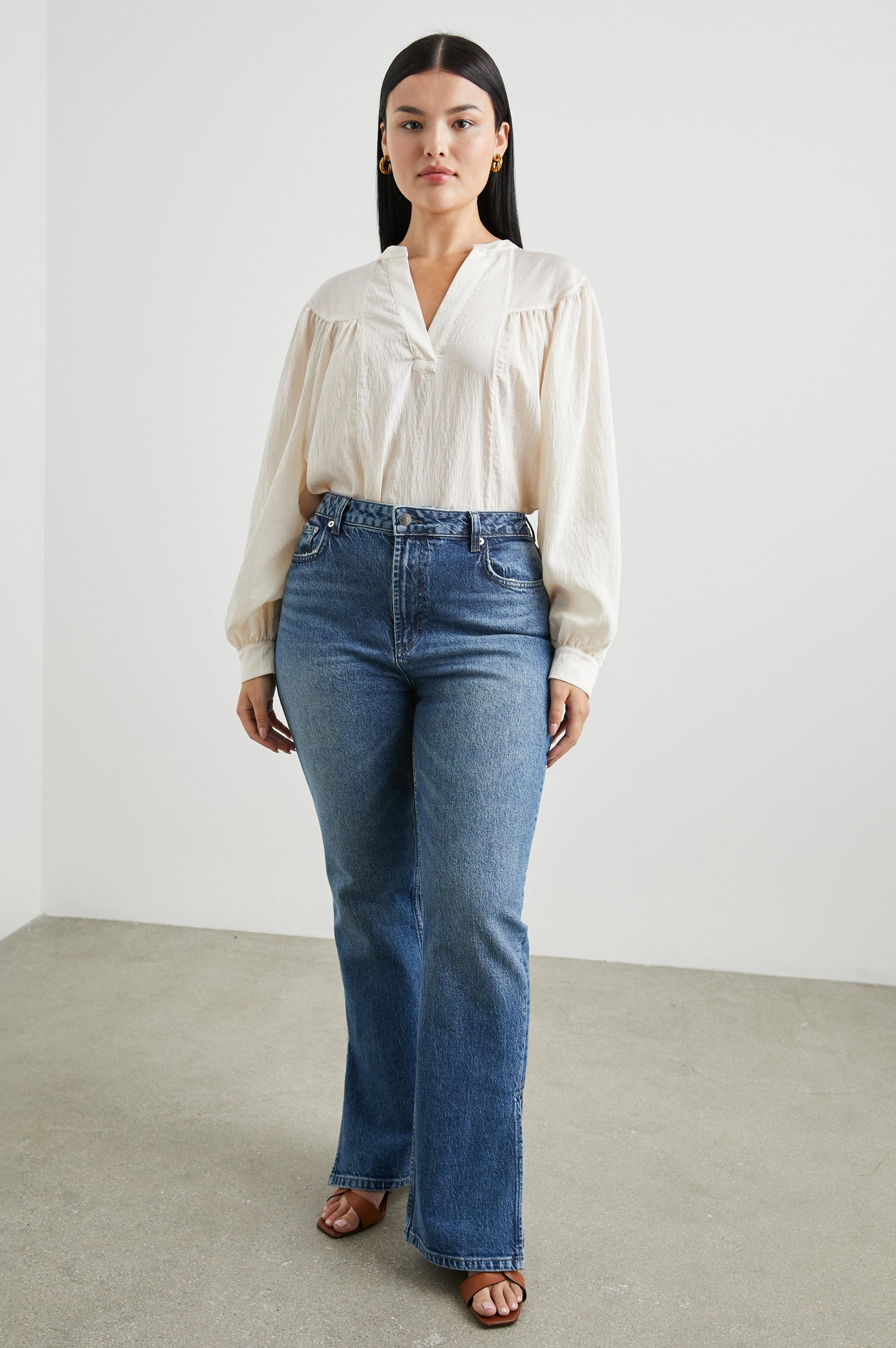 Fable Long Sleeve Top with a V Neck with a Placket, Buttoned Cuffs, and Pleating Down From the Yoke in Lotus Colorway - Front Full Body View Featured on Model 