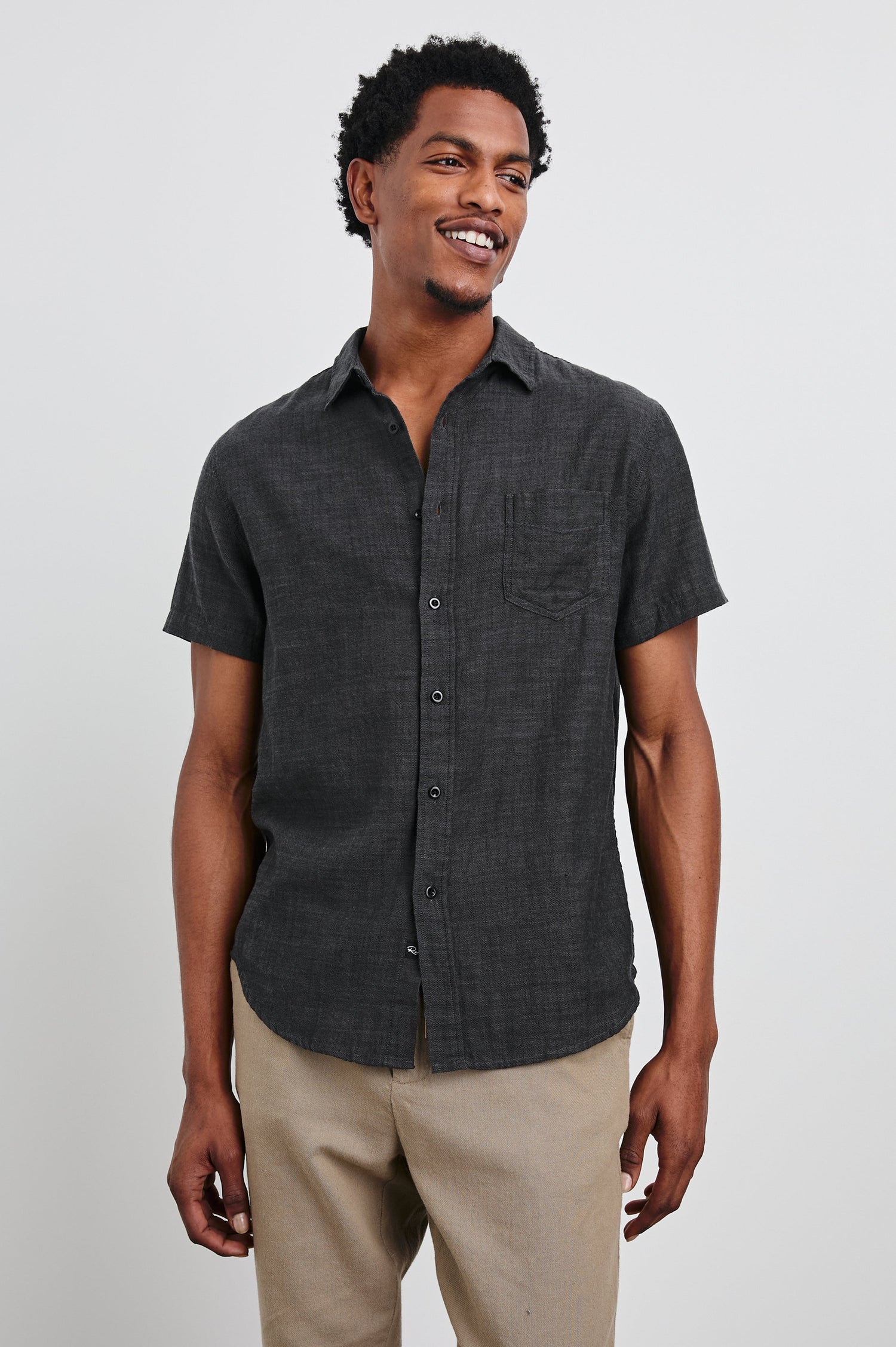 Fairfax Short-Sleeve Button Up with a Chest Patch Pocket in Black Chambray Colorway - Front View Featured on Model