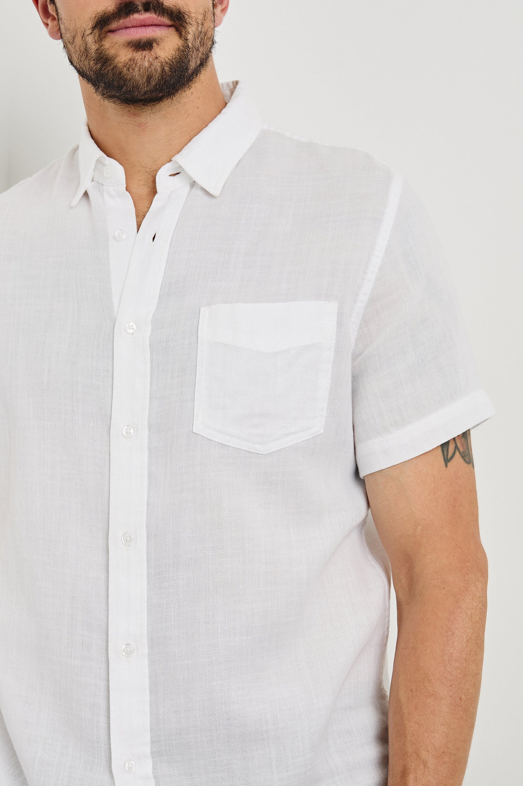 Fairfax short sleeve button up shirt with collar and chest pocket in White - close up of details on model