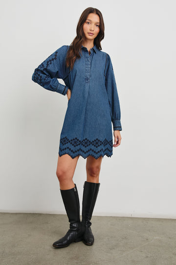 Fernanda Long-Sleeve Mini Dress with Button Cuffs, a Collar, a Placket with Buttons, a Scalloped Hem, a Floral Eyelet Design on the Sleeves and a Floral and Geometric Eyelet Design on the Hem in Dark Vintage Wash Colorway - Front Full Body View Featured on Model