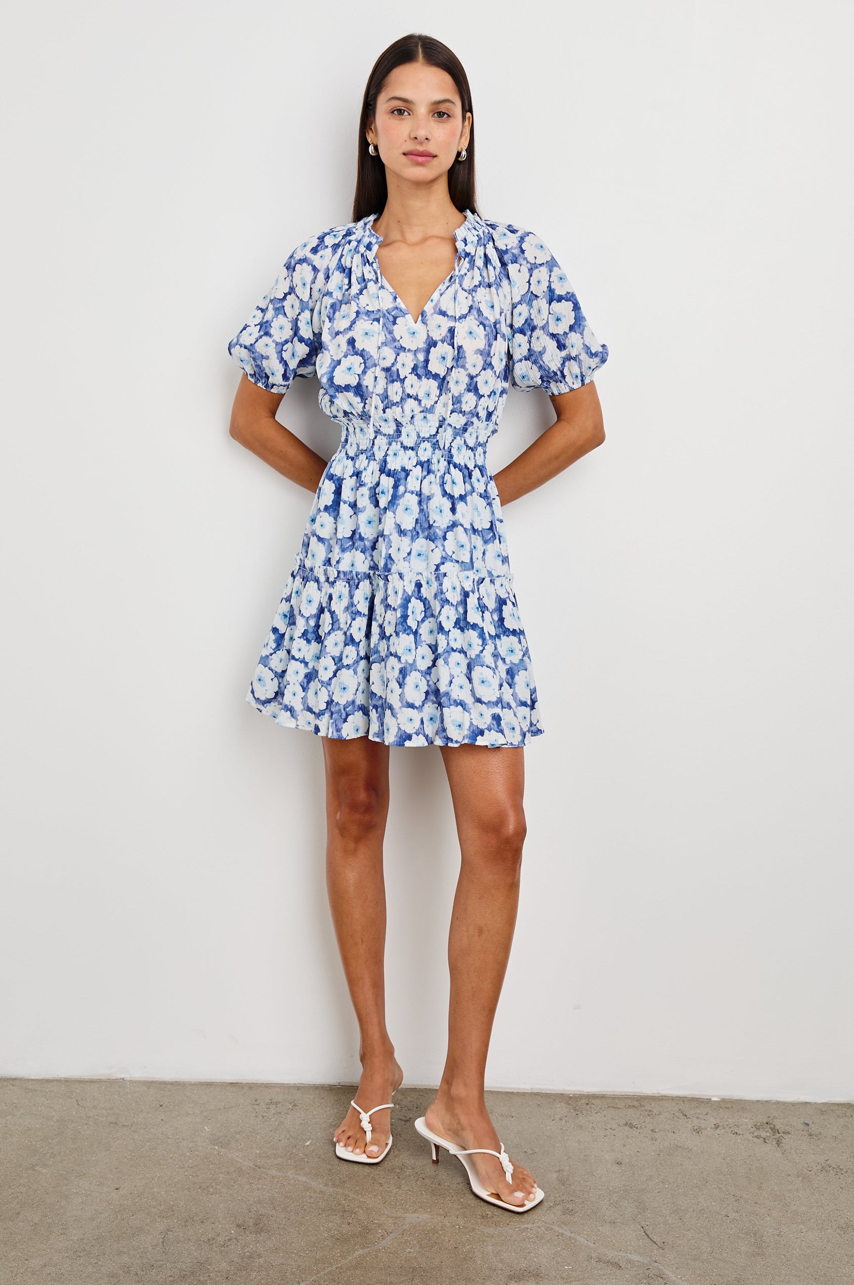 Fiorella Short-Sleeve, Above-Knee Dress with a Shirred Collar and Waist, V-neckline with Ties, Puff Sleeves and a Tiered Skirt in Blue Floral Colorway, Blues and White - Front Full Body View Featured on Model