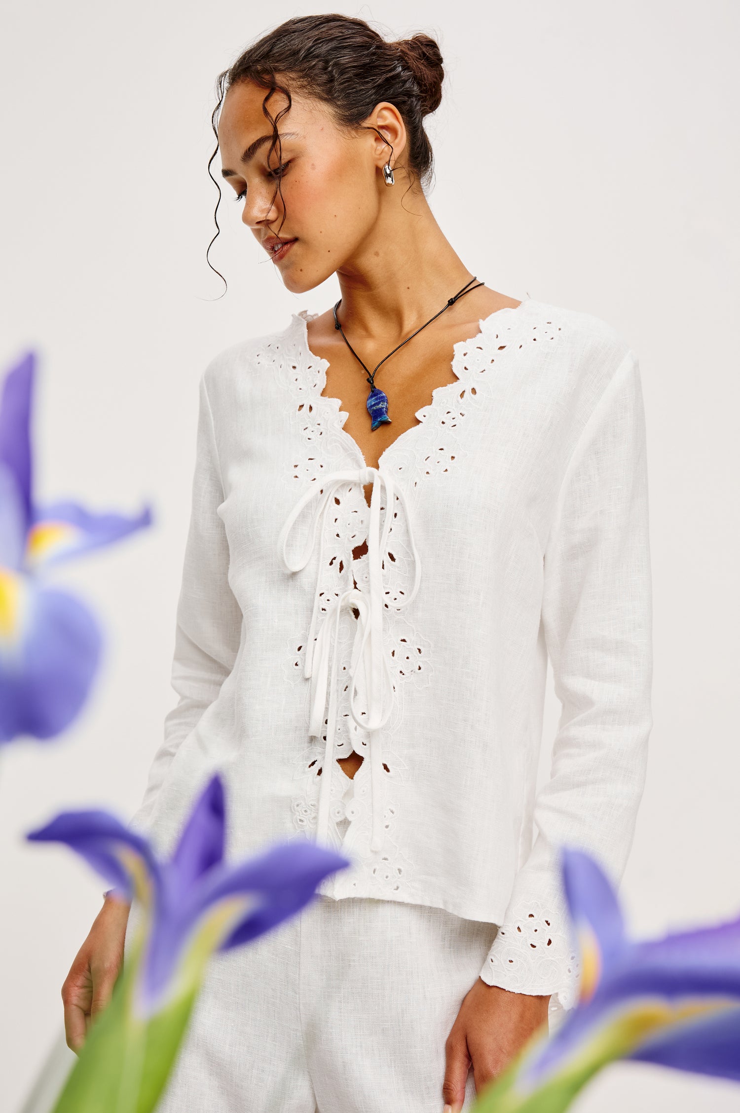 Fleur Top in Linen With Floral Eyelet Embroidery Open Front Adjustable Front Self-Ties Long Sleeves and Loose Fit in White - Upper Body Front View Featured on Model