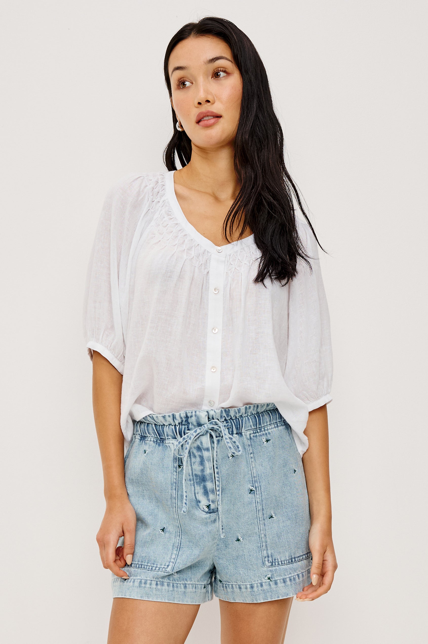 Foster Short in TENCEL™ Denim With High Drawstring Paperbag Waist With Adjustable Ties, Relaxed FIt, and Side and Back Pockets in Ivory Carnations Colorway - Lower Body Front View Featured on Model