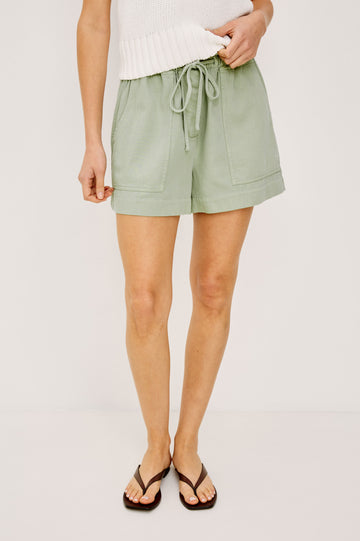 Foster Short in TENCEL™ Denim With High Drawstring Paperbag Waist With Adjustable Ties, Relaxed FIt, and Side and Back Pockets Vintage Sage Colorway - Lower Body Front View Featured on Model