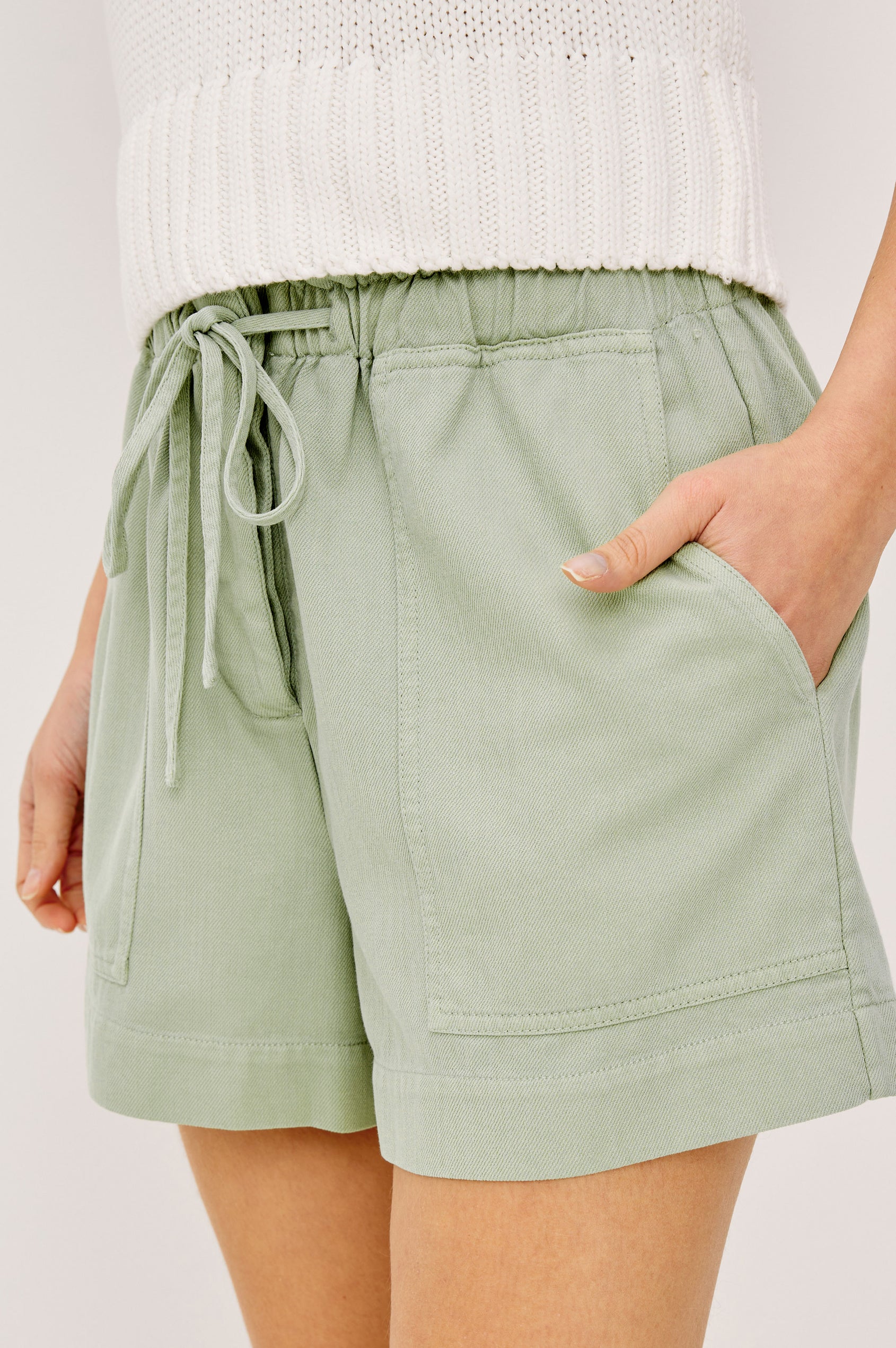 Foster Short in TENCEL™ Denim With High Drawstring Paperbag Waist With Adjustable Ties, Relaxed FIt, and Side and Back Pockets Vintage Sage Colorway - Lower Body Front View Featured on Model