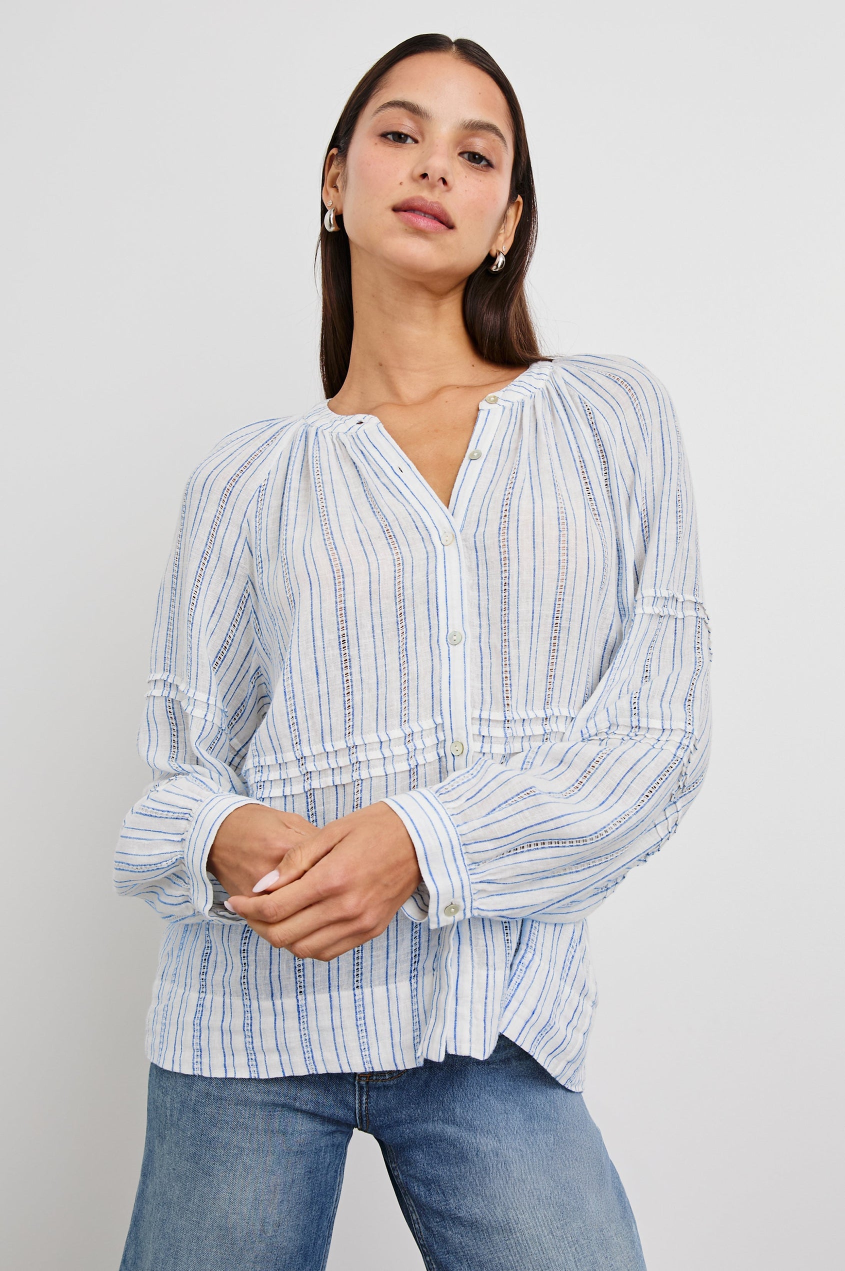 Frances Long-Sleeve Top with Buttons Down the Front, Button Cuffs, and Pleating Around the Neckline in Sonoma Stripe Colorway, Thin Blue Vertical Stripes on White - Front View Featured on Model