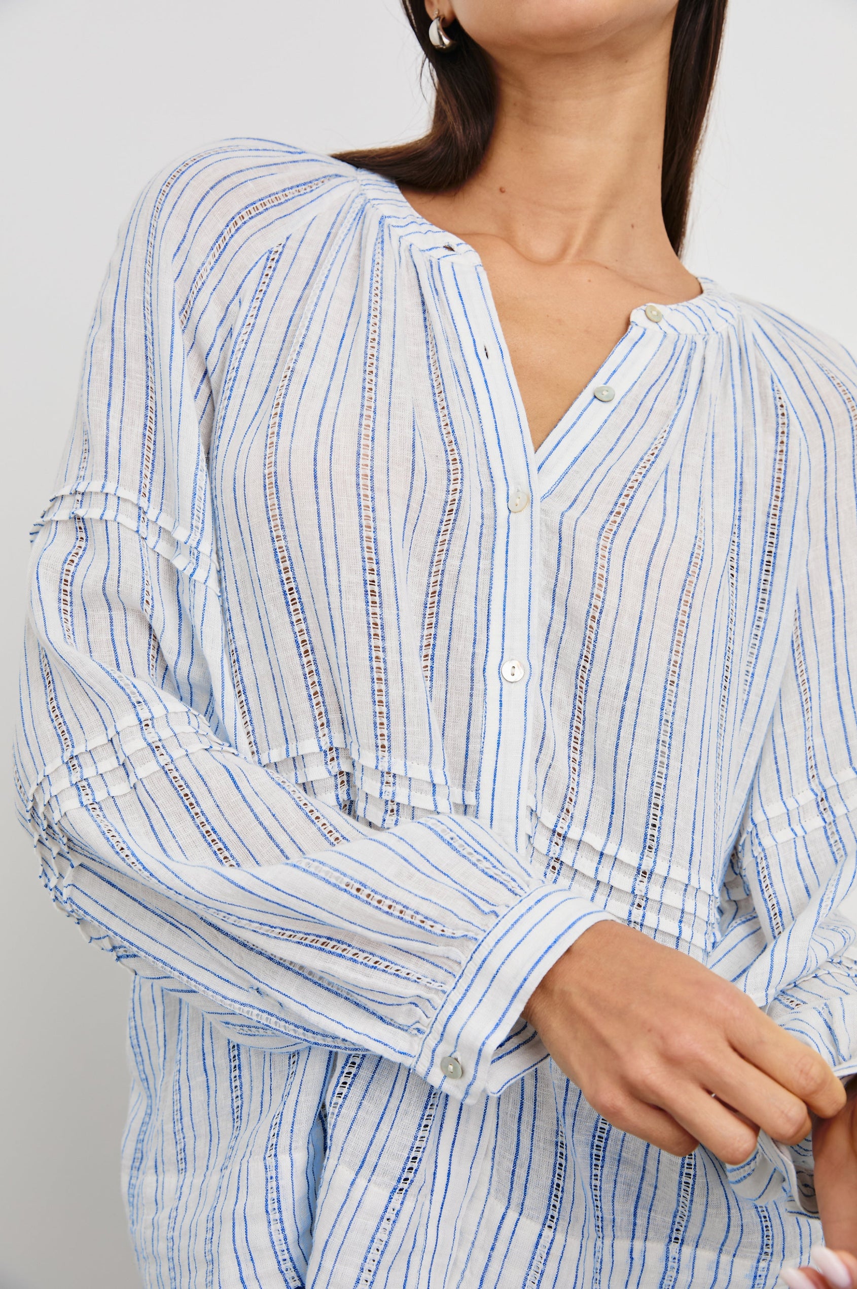 Frances Long-Sleeve Top with Buttons Down the Front, Button Cuffs, and Pleating Around the Neckline in Sonoma Stripe Colorway, Thin Blue Vertical Stripes on White - Front View Featured on Model