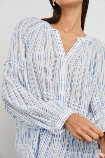 Frances Long-Sleeve Top with Buttons Down the Front, Button Cuffs, and Pleating Around the Neckline in Sonoma Stripe Colorway, Thin Blue Vertical Stripes on White - Front View Featured on Model