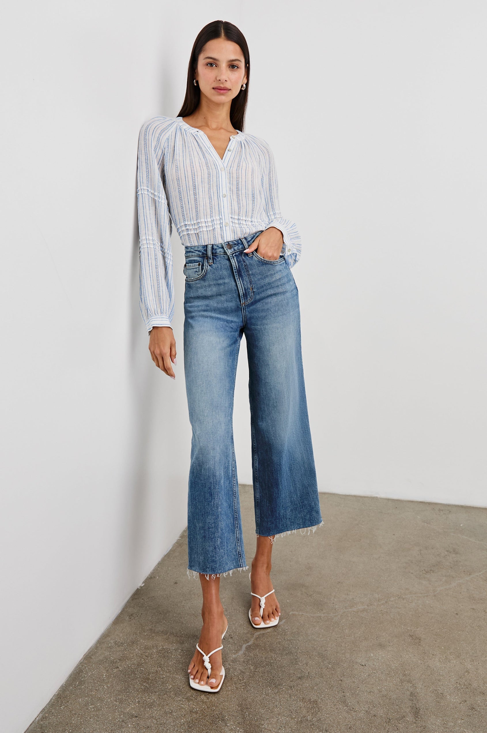 Frances Long-Sleeve Top with Buttons Down the Front, Button Cuffs, and Pleating Around the Neckline in Sonoma Stripe Colorway, Thin Blue Vertical Stripes on White - Front Full Body View Featured on Model