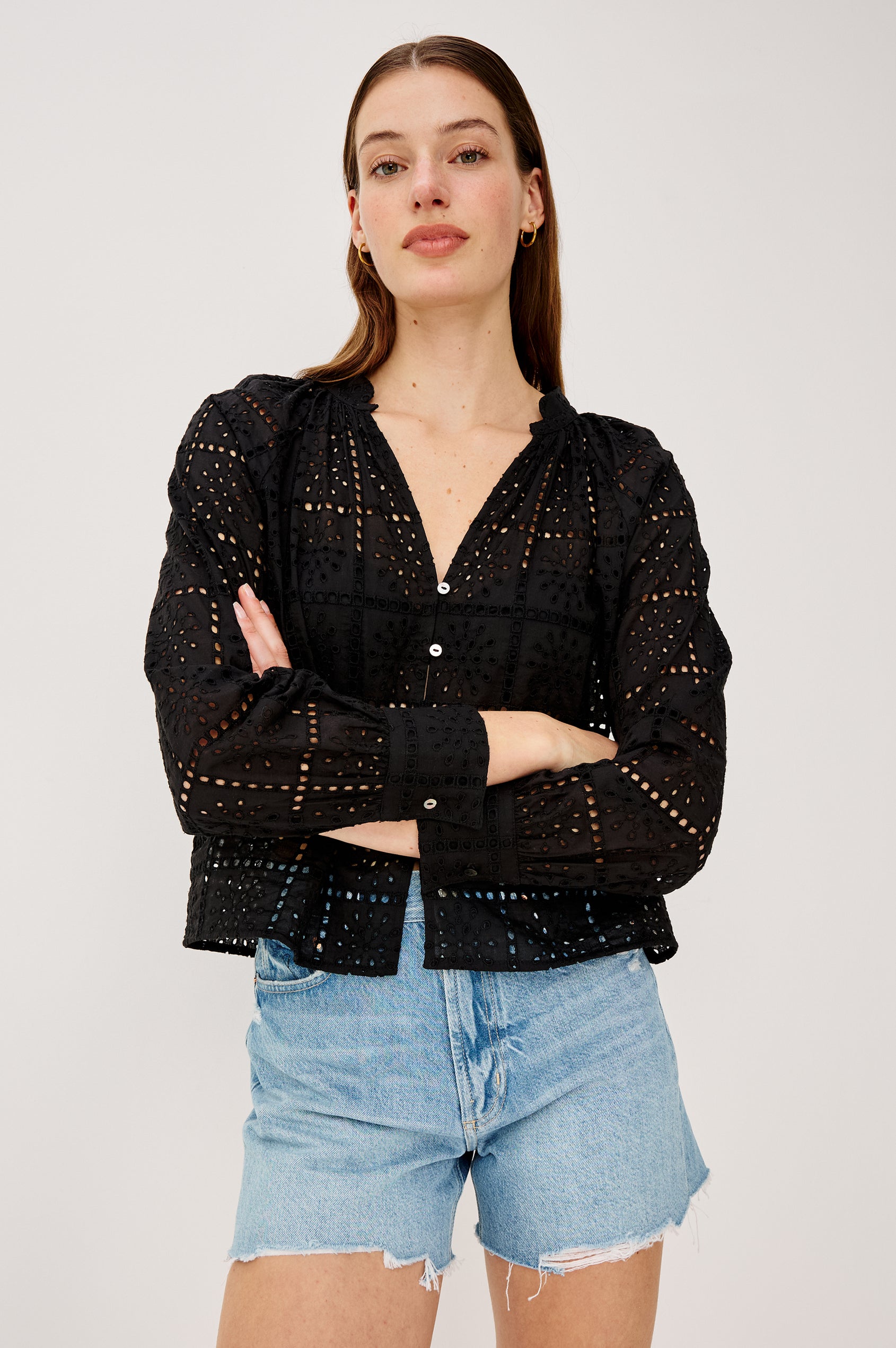 Francine Top in Cotton With Boxy FIt Front Buttons Split V-Neck Band Collar Semi-Sheer Embroidered Grid Floral Cutwork and Long Puff Sleeves With Fitted Cuffs in Black Grid Embroidery Colorway - Upper Body Front View Featured on Model