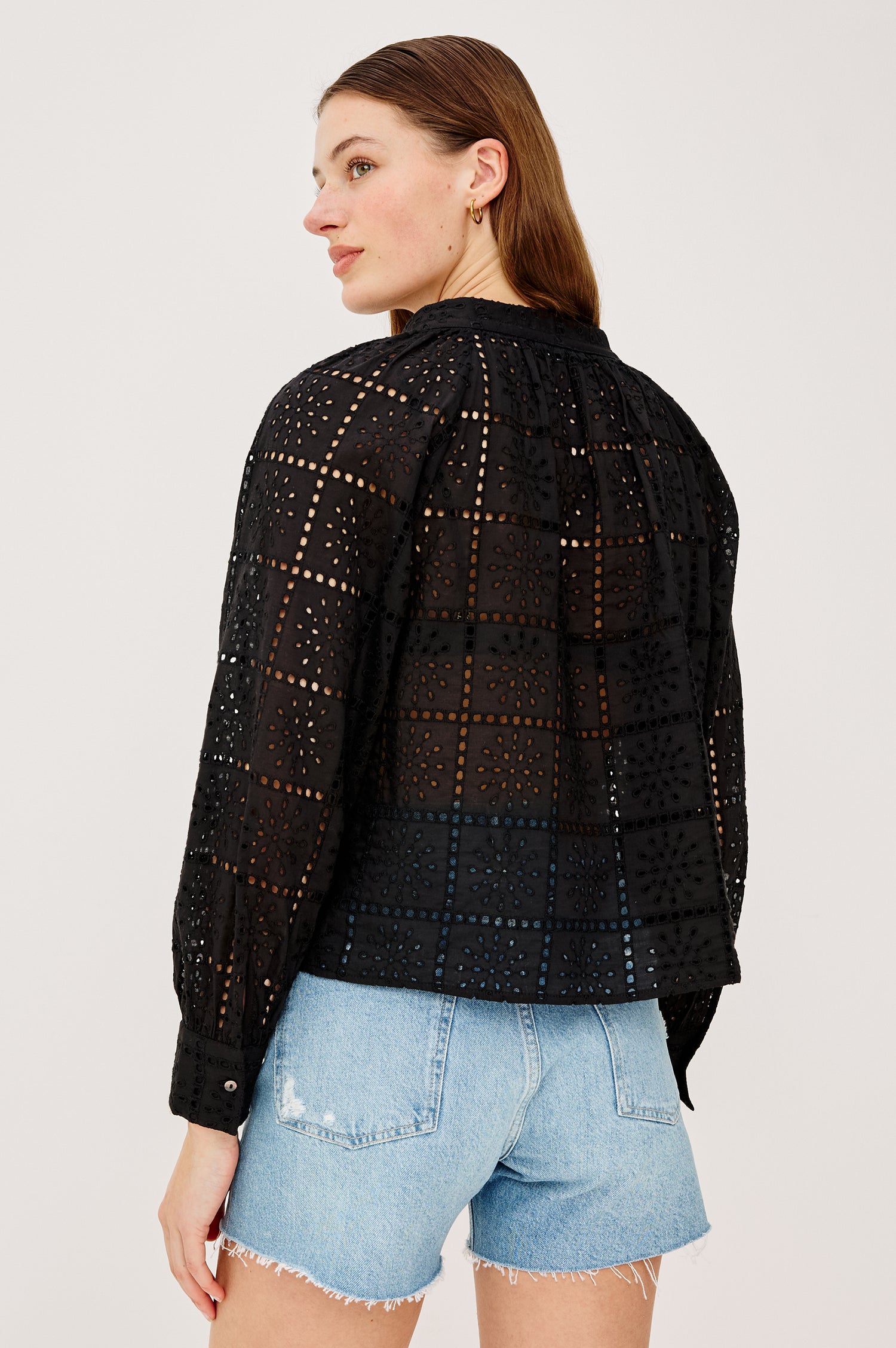 Francine Top in Cotton With Boxy FIt Front Buttons Split V-Neck Band Collar Semi-Sheer Embroidered Grid Floral Cutwork and Long Puff Sleeves With Fitted Cuffs - Upper Body Back View Featured on Model