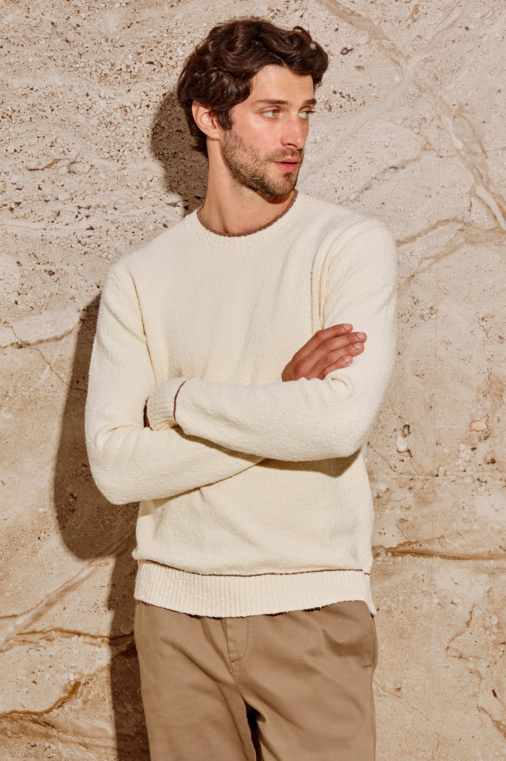 The Franco is a long sleeve crew neck sweater with contrast brown on neck, sleeve and hem in Cream colorway. Front view featured on model.