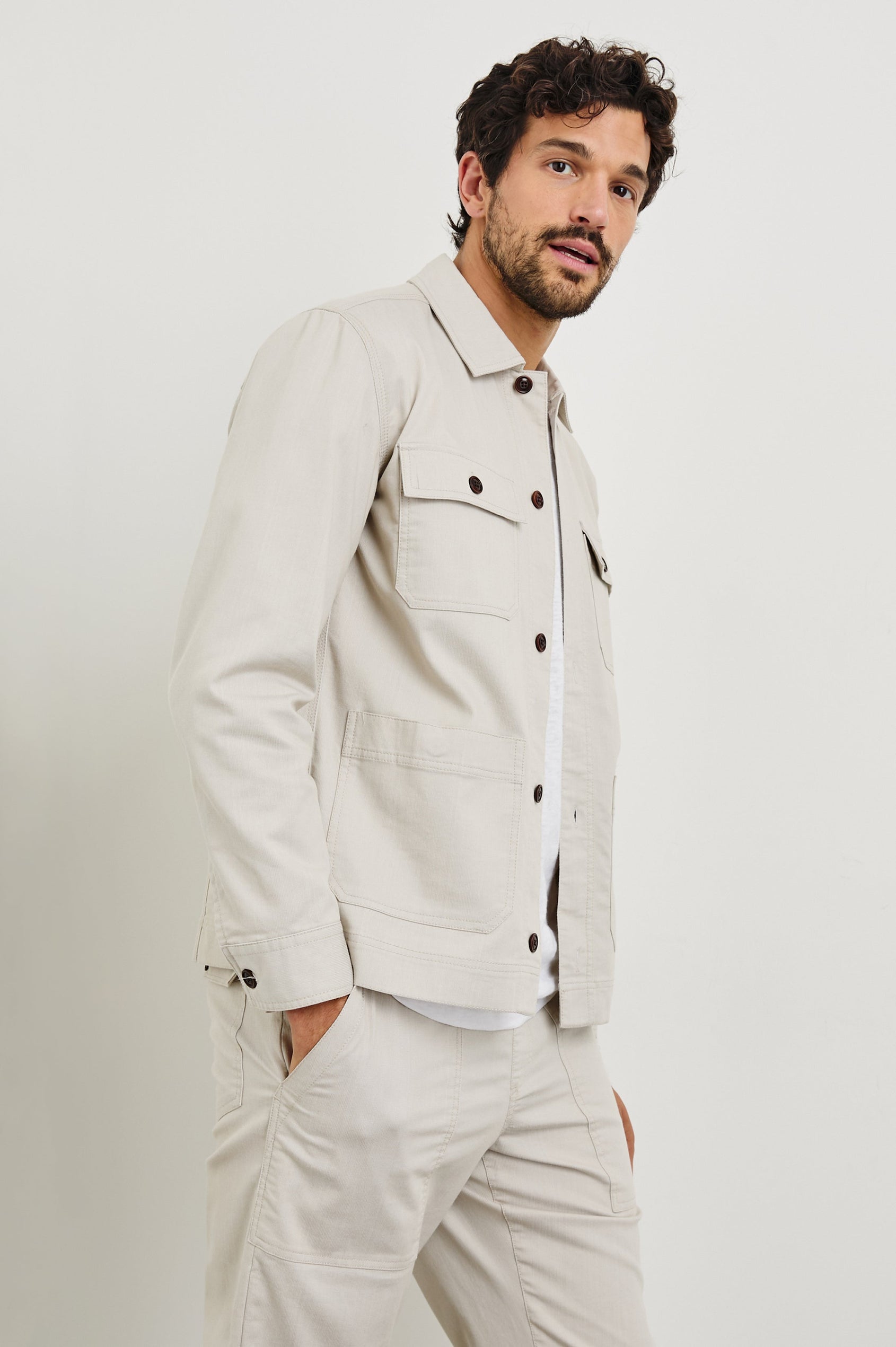 Franklin Jacket with Button Closure, Two Front Patch Pockets and Two Chest Button Flap Pockets in Oat Railroad Dobby Colorway - Side View Featured on Model