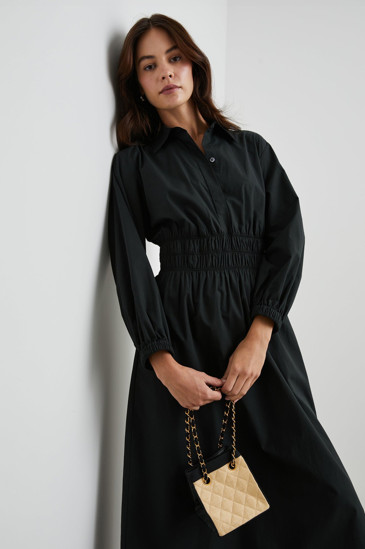 Fraya Long-Sleeve Midi Dress with a Concealed Button Placket on the Bodice, a Collar, a Shirred Waist, and Two Hip Pockets in Black Colorway - Front View Featured on Model 
