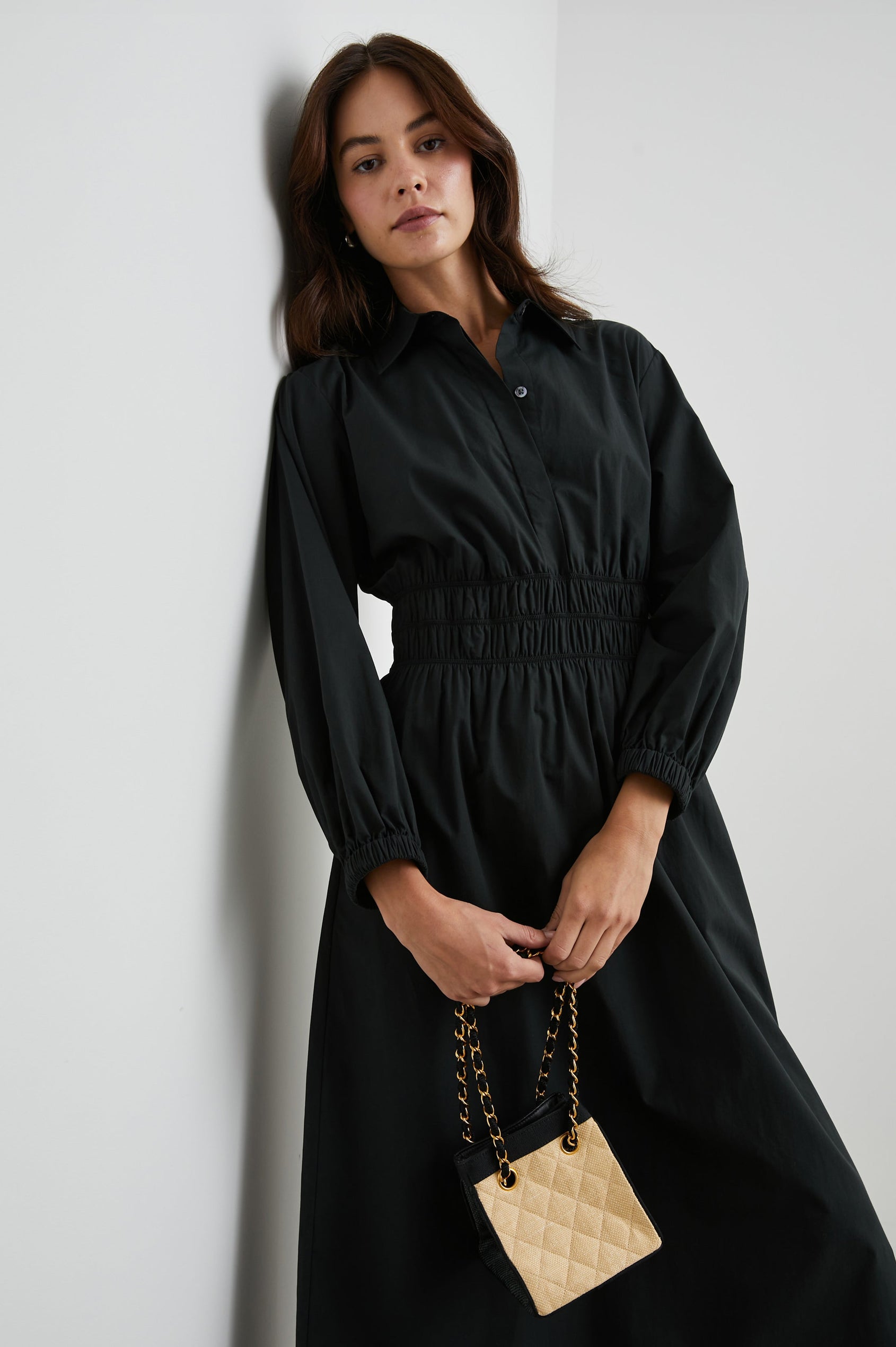 Fraya Long-Sleeve Midi Dress with a Concealed Button Placket on the Bodice, a Collar, a Shirred Waist, and Two Hip Pockets in Black Colorway - Front View Featured on Model 