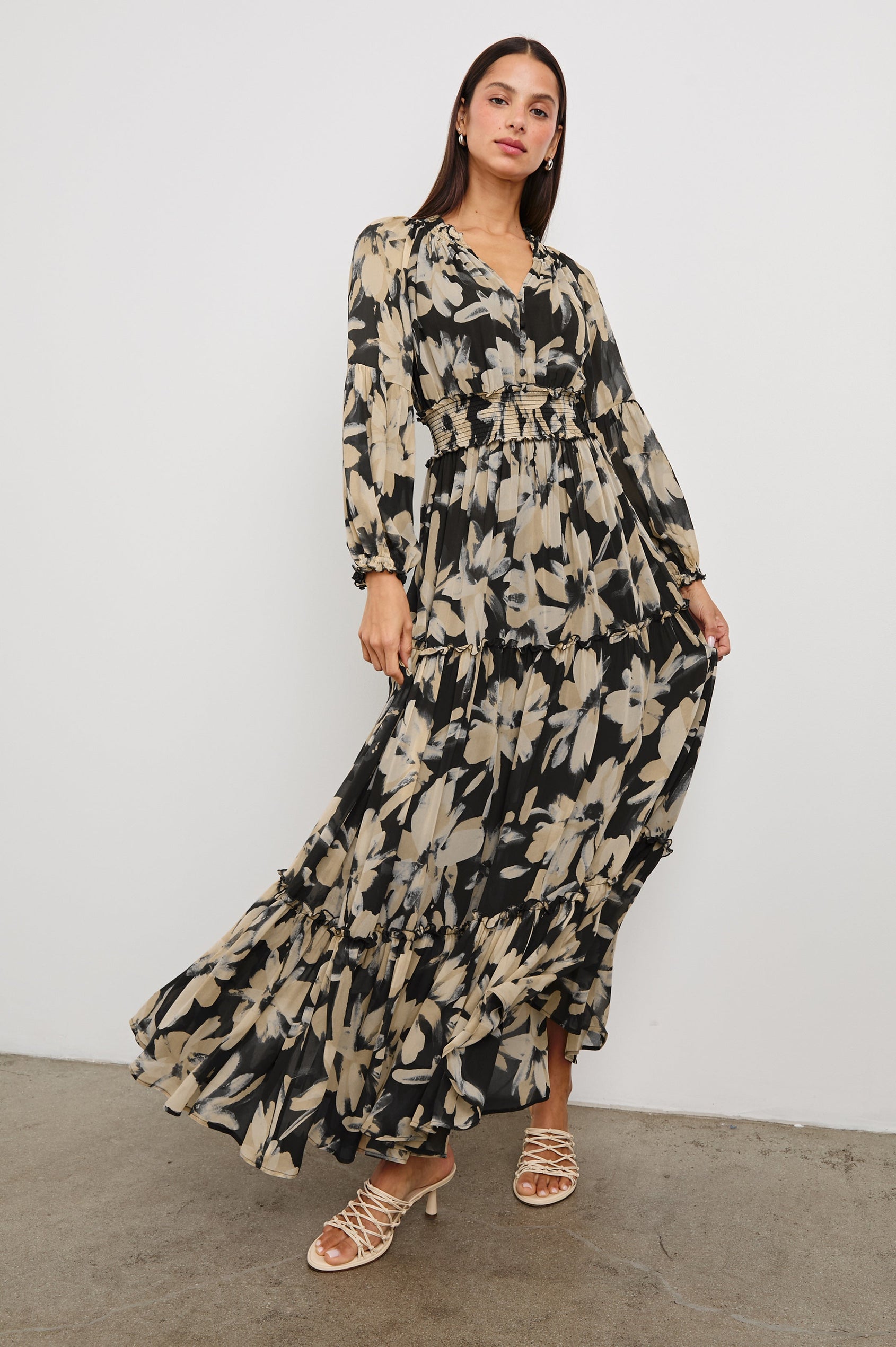 Frederica long sleeve flowy maxi dress with smocked neckline and waist and tiered skirt in Charcoal Lily - full body front view in motion