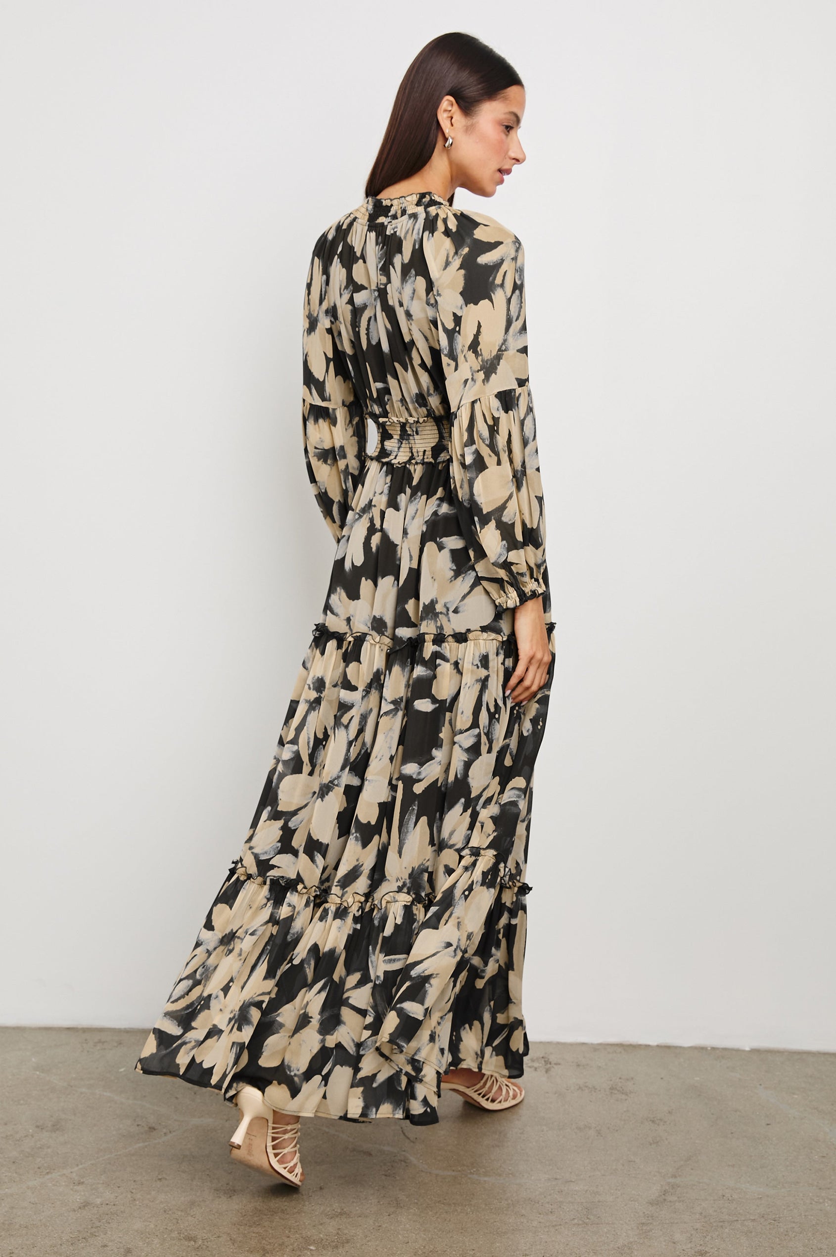 Frederica long sleeve flowy maxi dress with smocked neckline and waist and tiered skirt in Charcoal Lily - back view on model