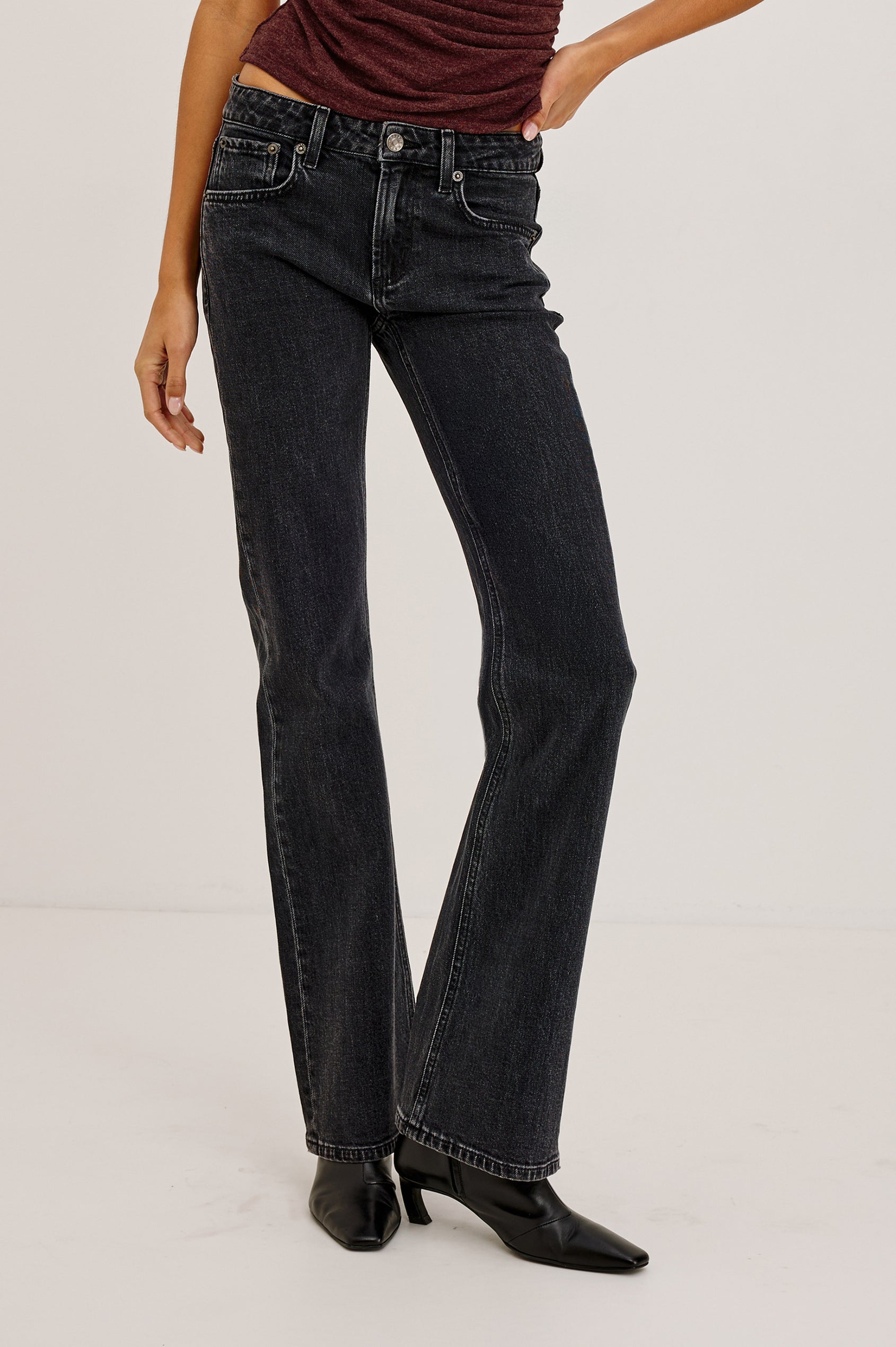Fremont Petite Low Rise Bootcut Jean in Light Stretch Denim With Extended Inseam, 5-Pockets, Distressed Details, Belt Loops, and Zip-Fly Closure in Blackjack Colorway - Lower Body Front View Featured on Model