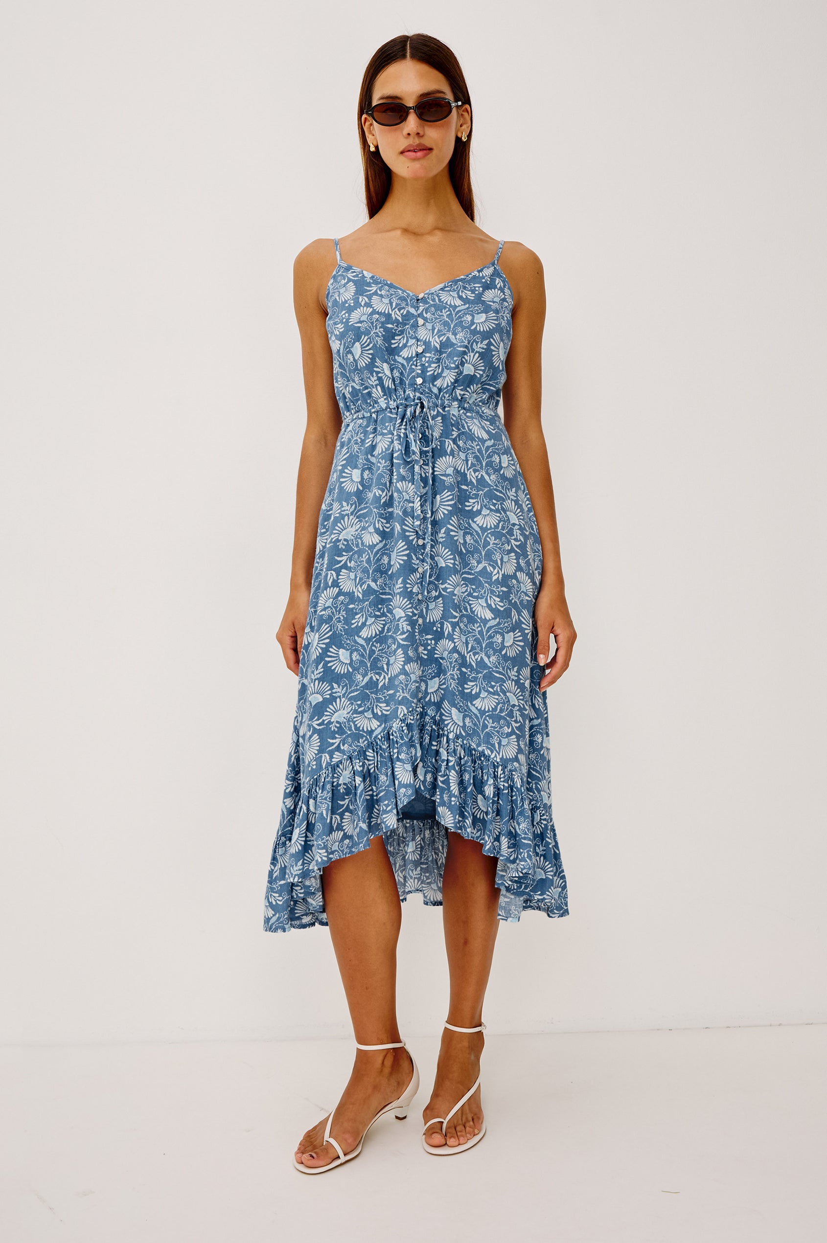 Frida Midi Dress in Luxe Linen With Center-Front Buttons, Adjustable Waist Ties, Adjustable Spaghetti Straps, High-Low Hem, and Full Cotton Lining in Blue Cassia Colorway - Full Body Front View Featured on Model