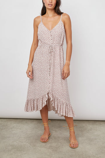 Frida Midi Dress with a Deep V Neck, Adjustable Spaghetti Straps, a Ruffled Hem, Drawstring Waist Ties and Buttons Down the Front in Garden Party Colorway, Pink Flowers on White - Front Full Body View Featured on Model