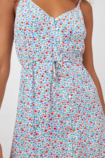 Frida Midi Dress with a Deep V Neck, Adjustable Spaghetti Straps, a Ruffled Hem, Drawstring Waist Ties and Buttons Down the Front in Wild Daisies Colorway, blue, Red and Pink Daisies on White - Front View Featured on Model