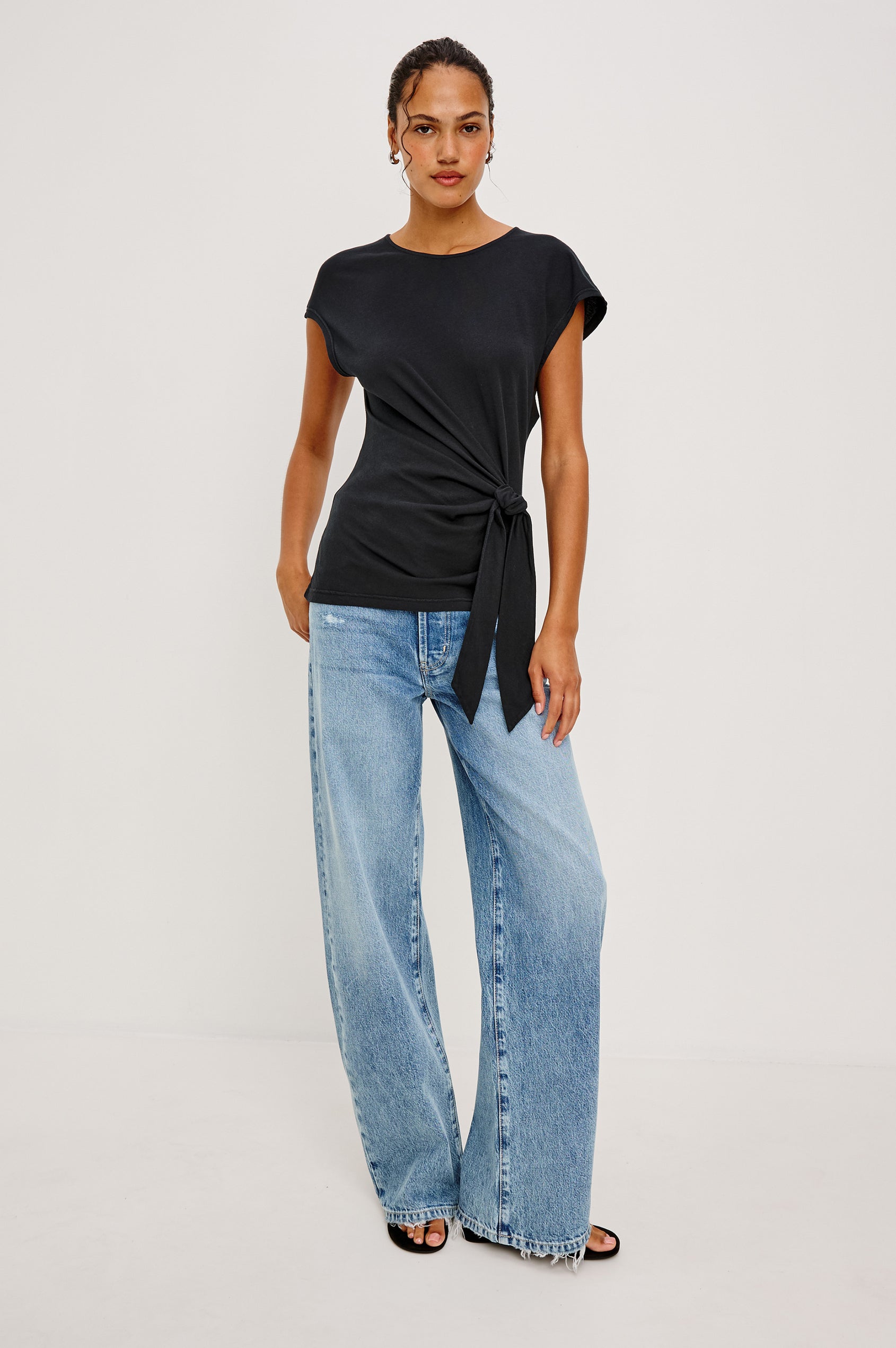 Gabbie Top in Cotton With Boat Neckline Dolman Cap Sleeves and Waist Wrap Ties in Black Colorway - Full Body Front View Featured on Model