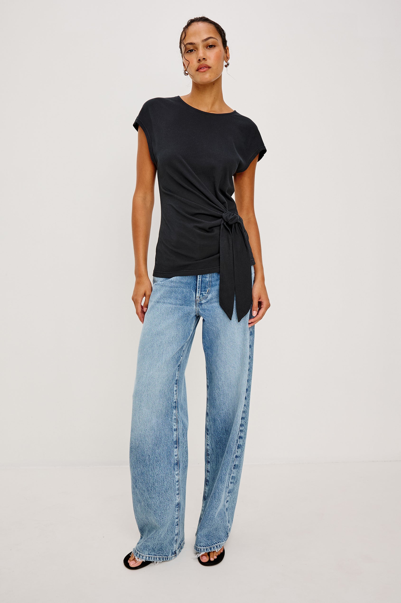 Gabbie Top in Cotton With Boat Neckline Dolman Cap Sleeves and Waist Wrap Ties in Black Colorway - Full Body Front View Featured on Model