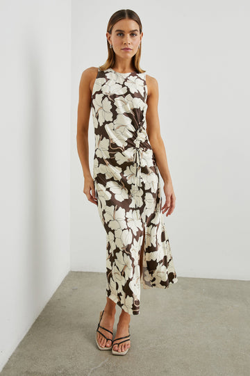Gabriella Sleeveless Midi Dress with a Crew Neck, a Left Thigh Side Slit, a Ruched Drawstring on the Left Side and a Keyhole Button Closure at the Back in Mocha Floral Colorway, Flowers in Cream and Tan on Mocha - Front Full Body View Featured on Model 