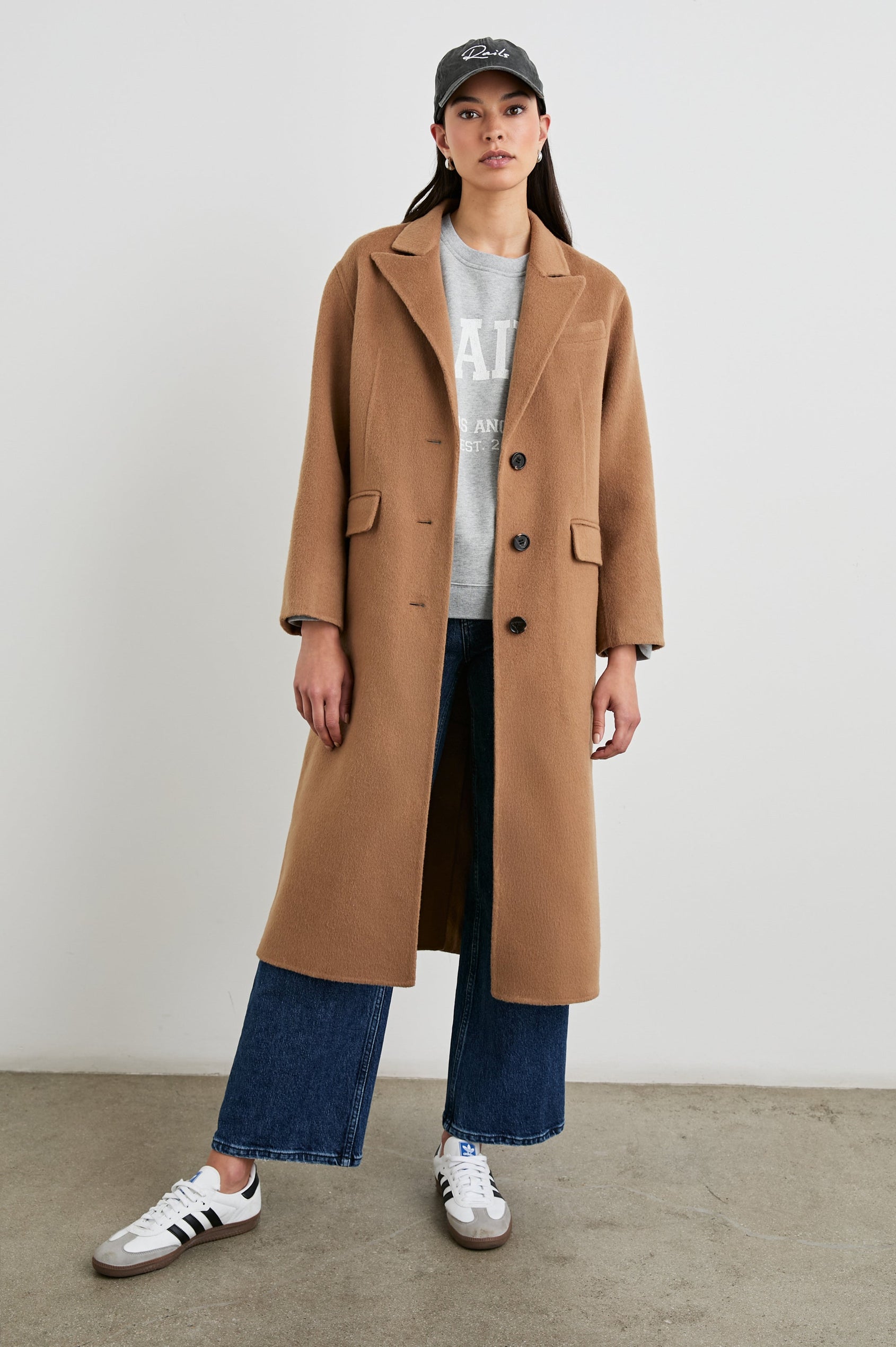 Gallery Below-the-Knee Coat with Three-Button Closure, Notched Lapels, and Two Front Flap Pockets in Camel Colorway - Front Full Body View Featured on Model