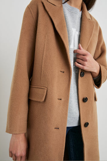 Gallery Below-the-Knee Coat with Three-Button Closure, Notched Lapels, and Two Front Flap Pockets in Camel Colorway - Front View Featured on Model