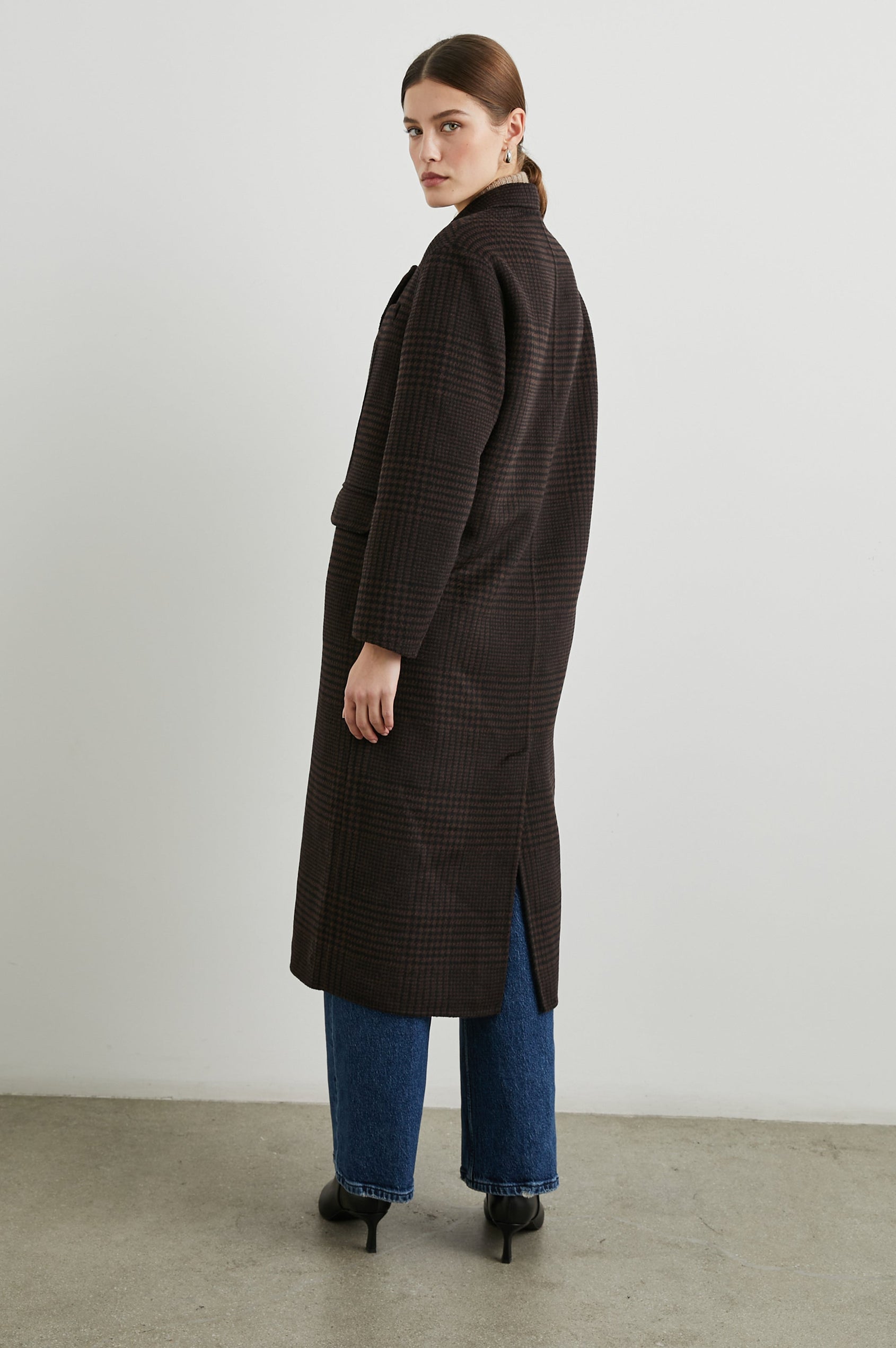 Gallery Below-the-Knee Coat with Three-Button Closure, Notched Lapels, and Two Front Flap Pockets in Espresso Houndstooth Colorway - Side Full Body View Featured on Model