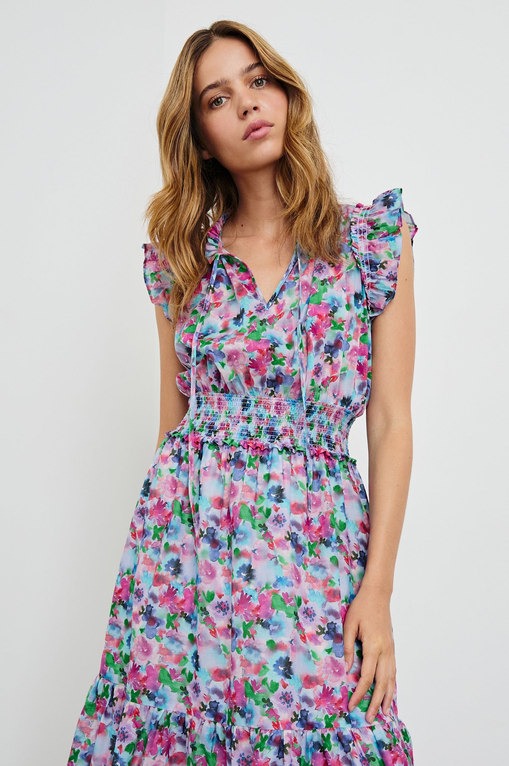 Garden Midi Dress with Flutter Cap Sleeves, Drawstrings at Neck and Shirred Waistband in Spring Meadow Colorway, Flowers in Pinks, Blues and Green - Front View Featured on Model