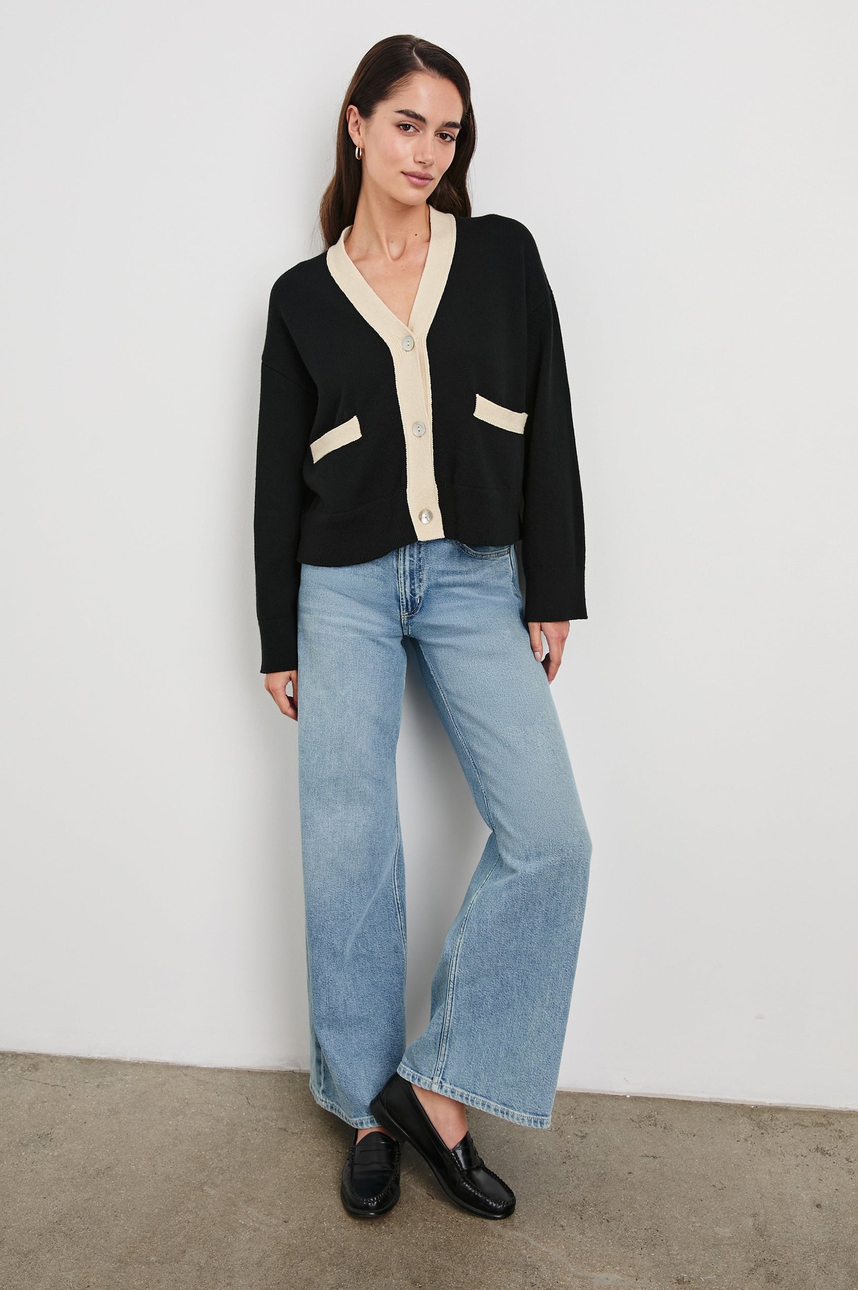 Geneva Long-Sleeve Cardigan with Two Front Patch Pockets and Button Closure in Black Ivory Colorway, with Ivory neckline, closure and pocket openings on Black - Front Full Body View Featured on Model