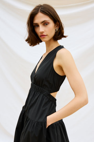 Genevieve Midi Tank Dress with Low V-Neck, Encased Elastic Waistband, Back Waist Cutout and Tiered A-Line Skirt in Black Colorway. Stylized Close Up View Shown on Model.