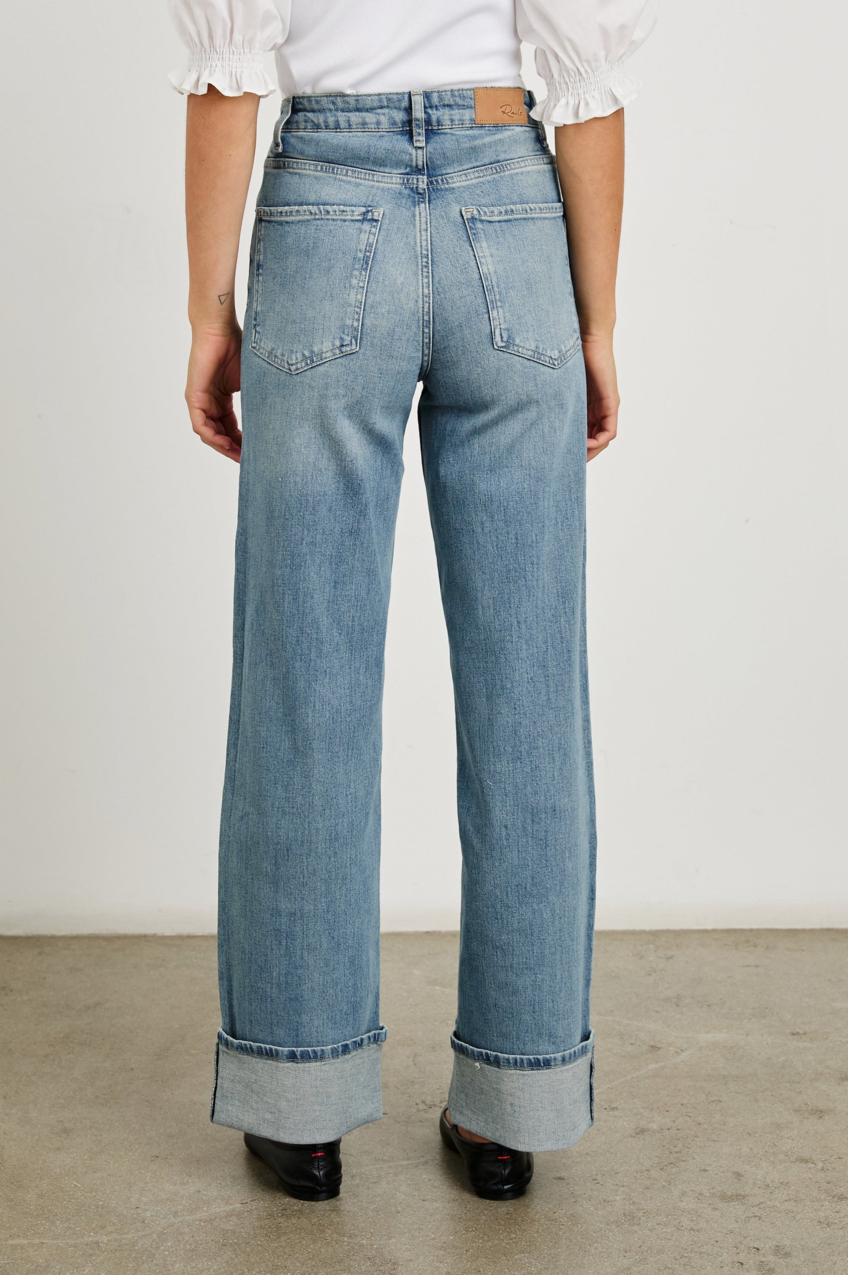 Getty Wide Leg Denim Pants with Cuffed Hems, Belt Loops, Two Front Pockets and Two Back Patch Pockets in Baltic Sea Cuffed Colorway - Back View Featured on Model