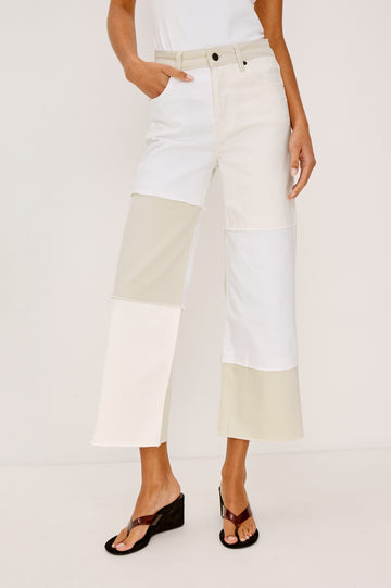 Getty Crop 5-Pocket Denim Pant with Tonal constrast from Panels with raw edges, Traditional Zip and Button Fly and Belt Loops in Ecru Patchwork Colorway. Full Body Front View Shown on Model.