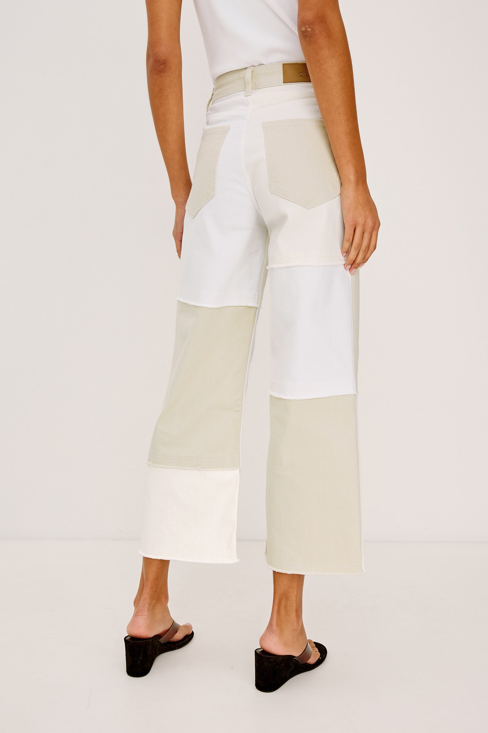 Getty Crop 5-Pocket Denim Pant with Tonal constrast from Panels with raw edges, Traditional Zip and Button Fly and Belt Loops in Ecru Patchwork Colorway. Back View Shown on Model.