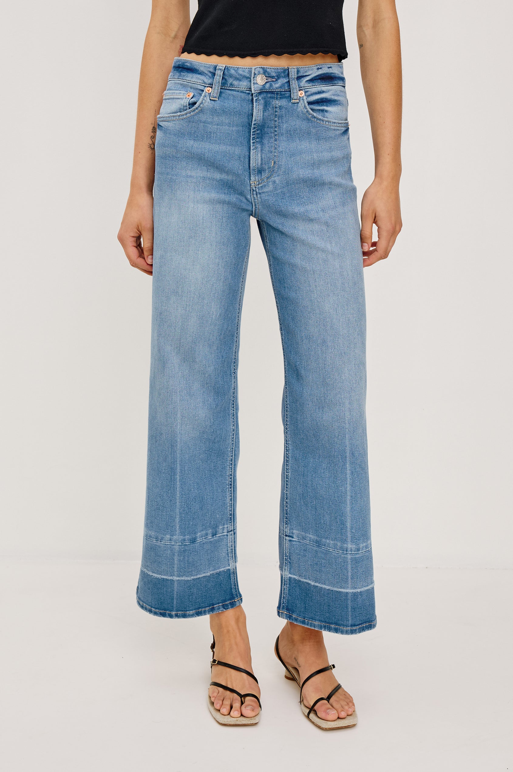 Getty Crop Jean in Light Stretch Denim With Wide Straight Legs, 27″ Inseam, Released Hem, Floral Embroidery, 5-Pockets, and Zip Fly in Independence Colorway - Full Body Front View Featured on Model