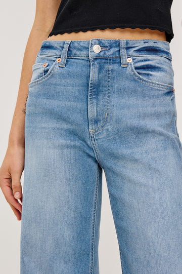 Getty crop isa a 5-pkt wide leg jean in Independence colorway, a medium wash with a released hem - close up front view featured on model.