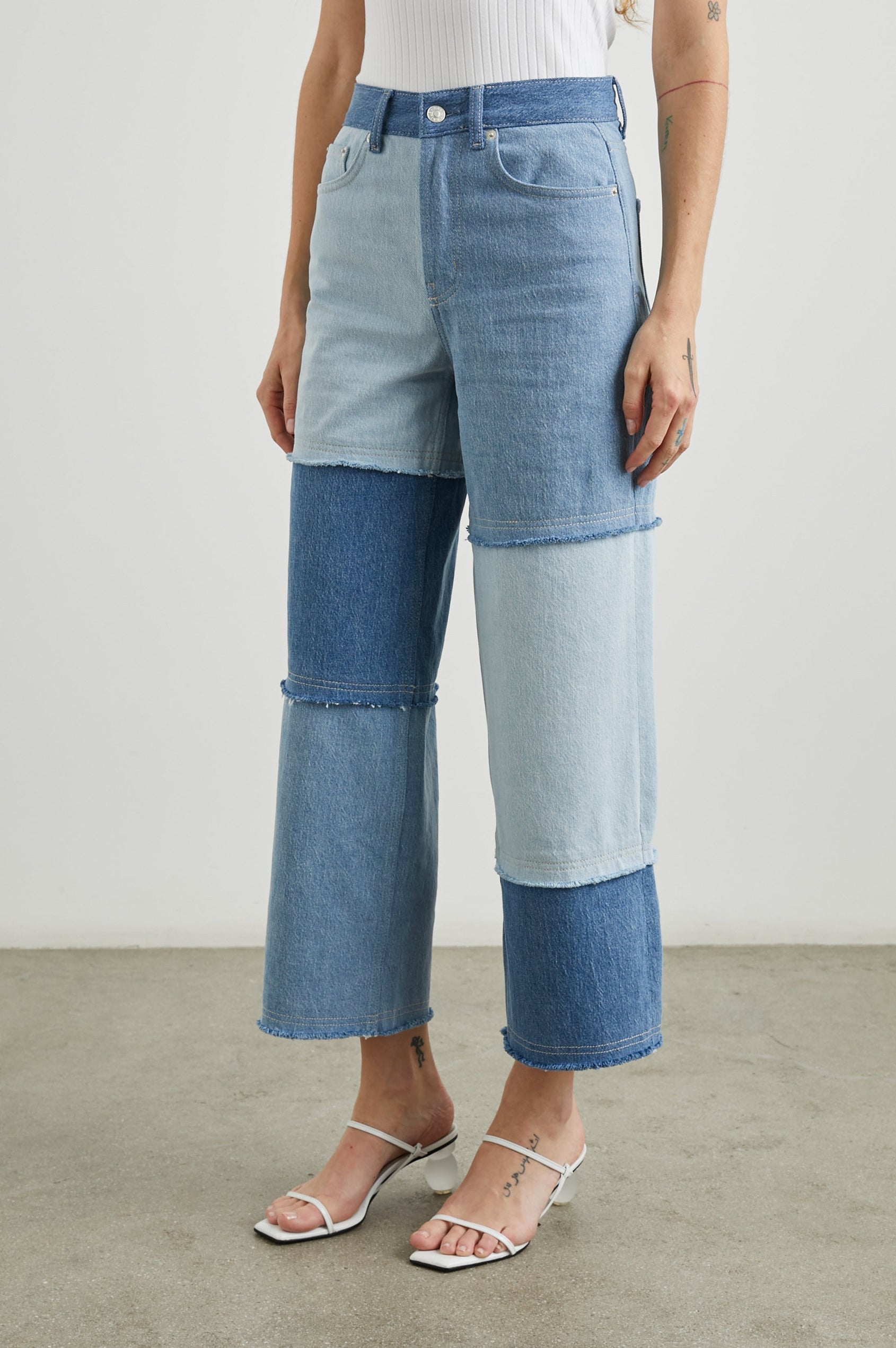 Getty Crop Wide Leg Denim Pants with Belt Loops, Two Front Pockets and Two Back Patch Pockets in Light Indigo Patchwork Colorway, with large patches in blues - Front View Featured on Model