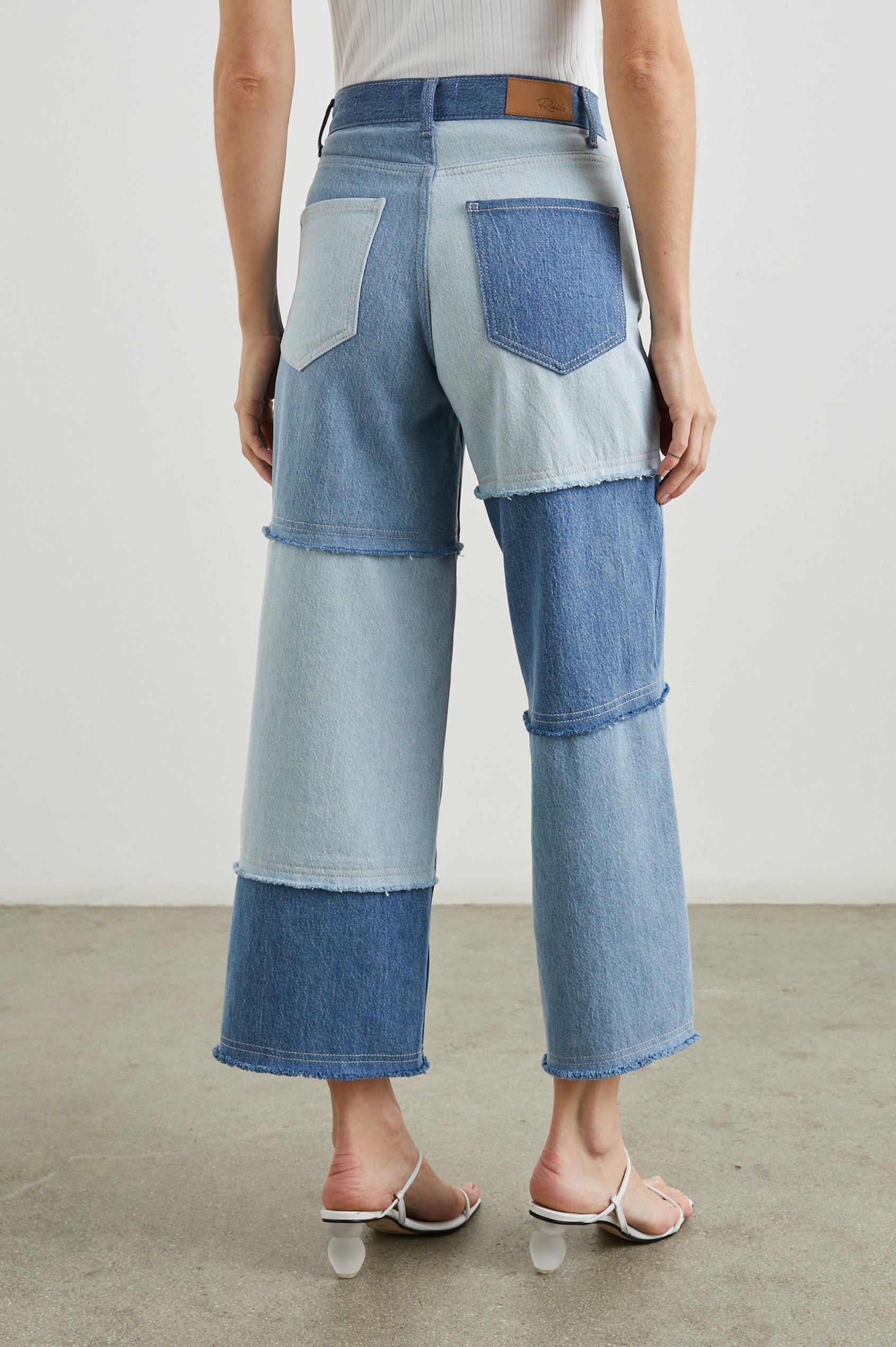 Getty Crop Wide Leg Denim Pants with Belt Loops, Two Front Pockets and Two Back Patch Pockets in Light Indigo Patchwork Colorway, with large patches in blues - Back View Featured on Model
