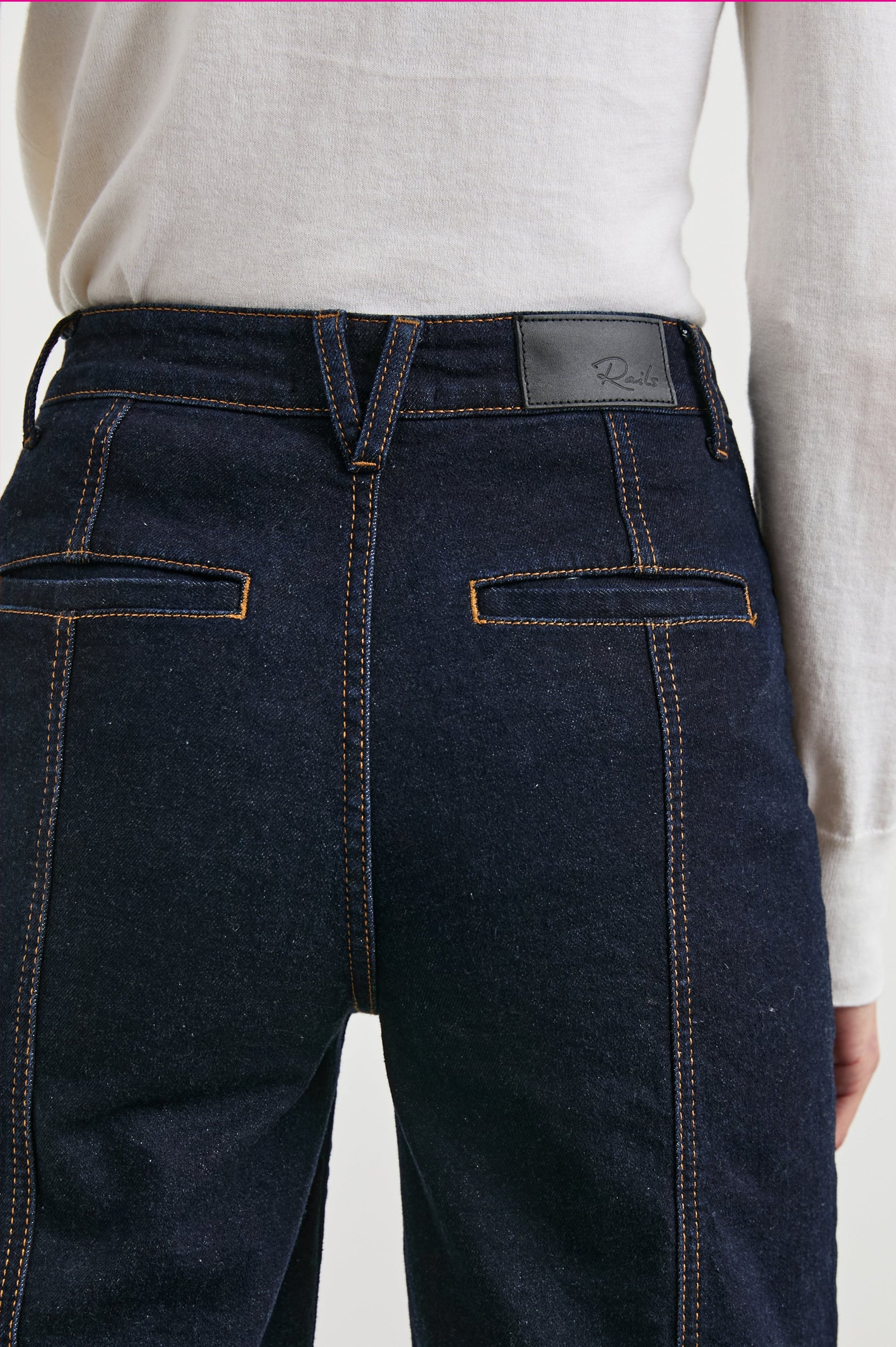 Getty Crop Utility Wide Leg Denim Pants with Belt Loops, Additional Seams, Two large Front Pockets and Two Back Patch Pockets in Midnight Blues Colorway, Gold Tone Stitching along Seams - Back View Featured on Model