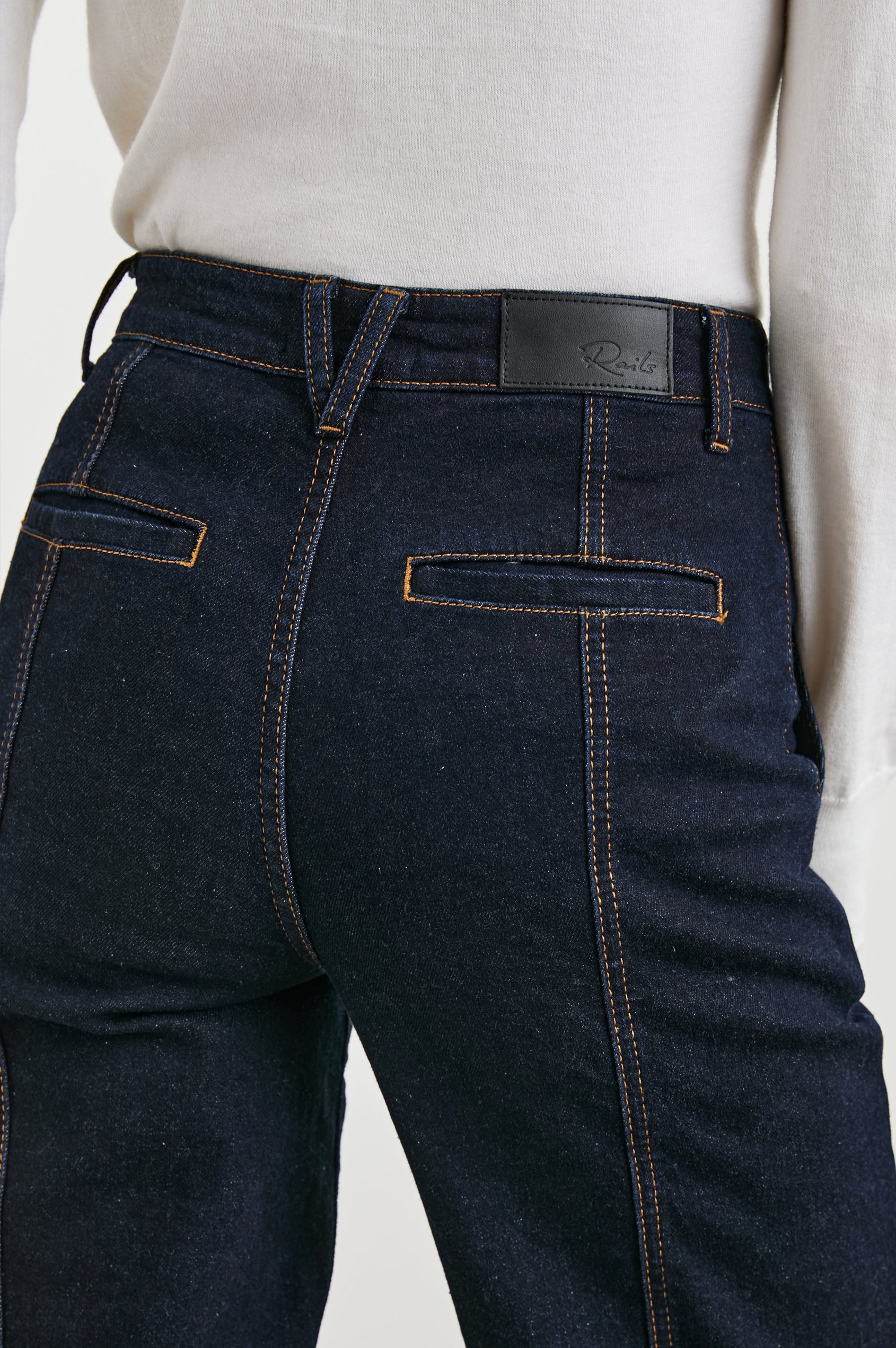 Getty Crop Utility Wide Leg Denim Pants with Belt Loops, Additional Seams, Two large Front Pockets and Two Back Patch Pockets in Midnight Blues Colorway, Gold Tone Stitching along Seams - Back View Featured on Model