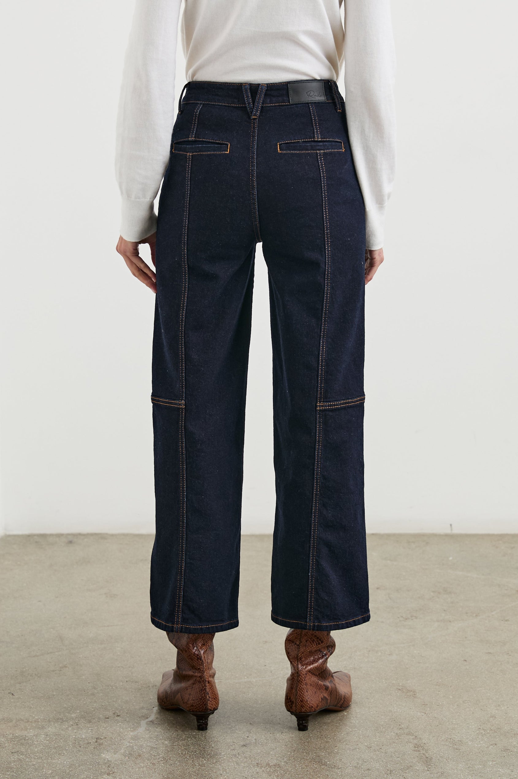 Getty Crop Utility Wide Leg Denim Pants with Belt Loops, Additional Seams, Two large Front Pockets and Two Back Patch Pockets in Midnight Blues Colorway, Gold Tone Stitching along Seams - Back View Featured on Model