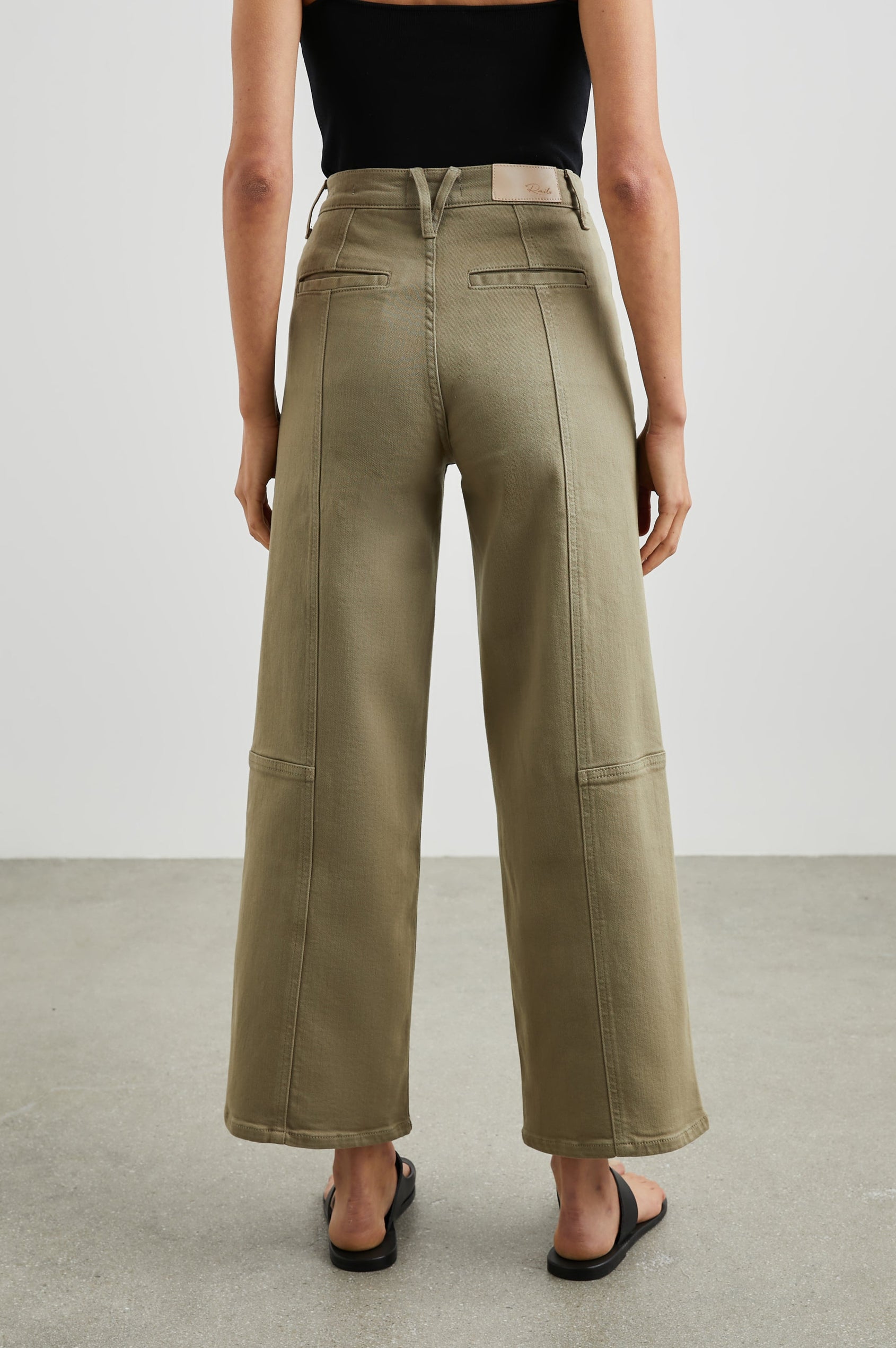 Getty Crop Utility Wide Leg Denim Pants with Belt Loops, Additional Seams, Two large Front Pockets and Two Back Patch Pockets in Washed Olive Colorway - Back View Featured on Model