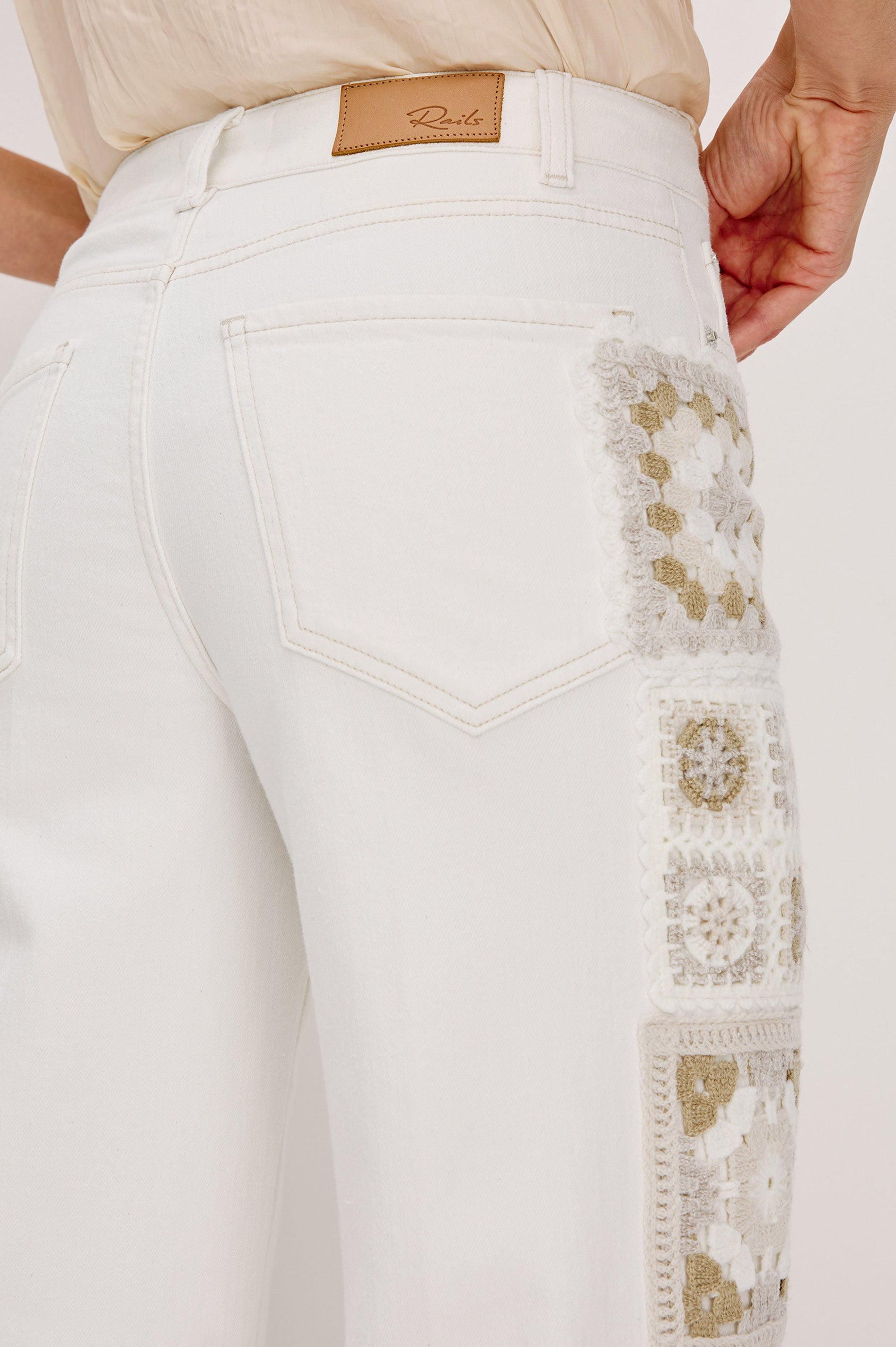 Getty Crop 5-Pocket Denim Pant with Tonal Crochet Side Seam Panels, Traditional Zip and Button Fly and Belt Loops in Vintage Ecru Crochet Colorway. Back Detail View Shown on Model.